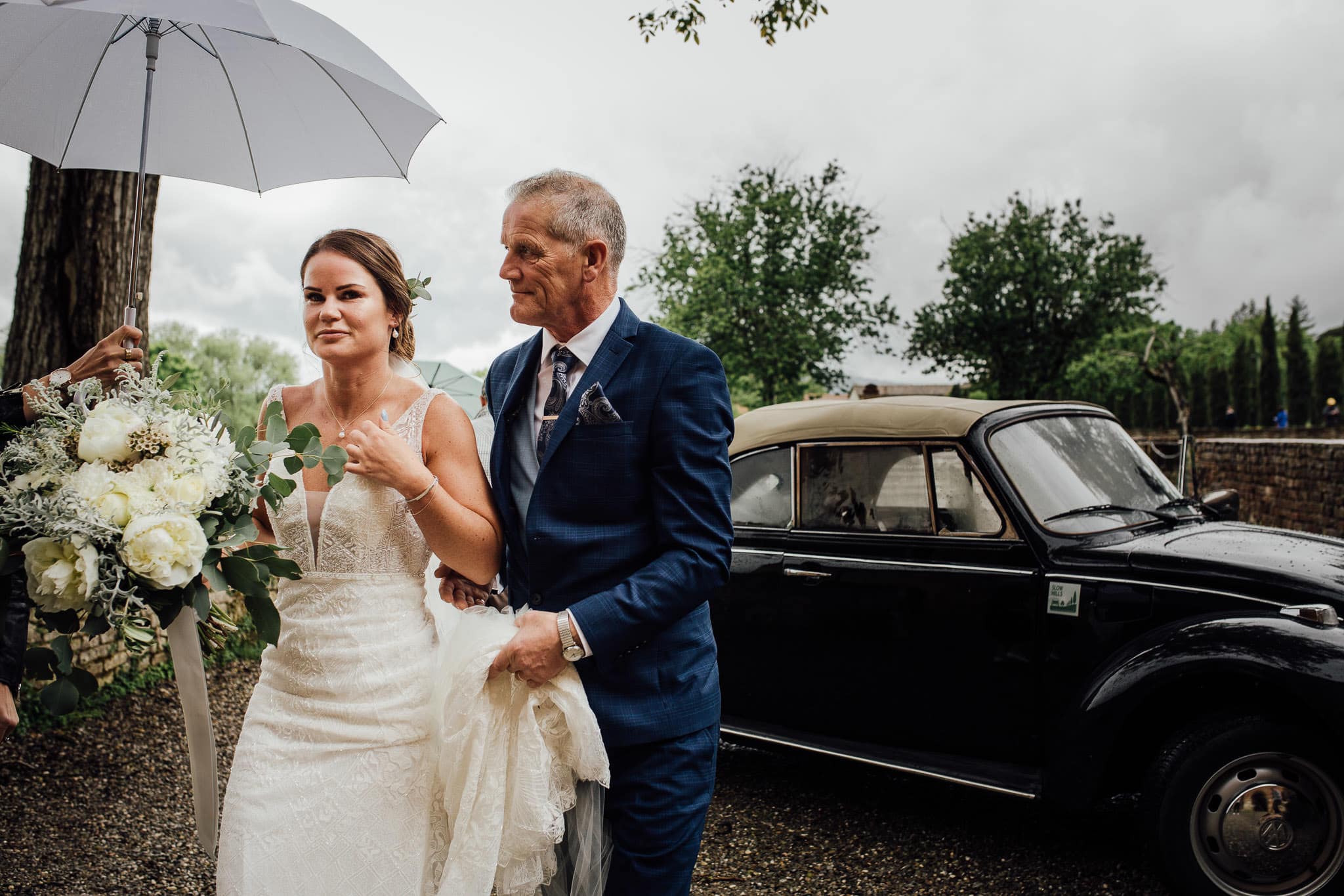 bride arriving at San Galgano Abbey in the rain