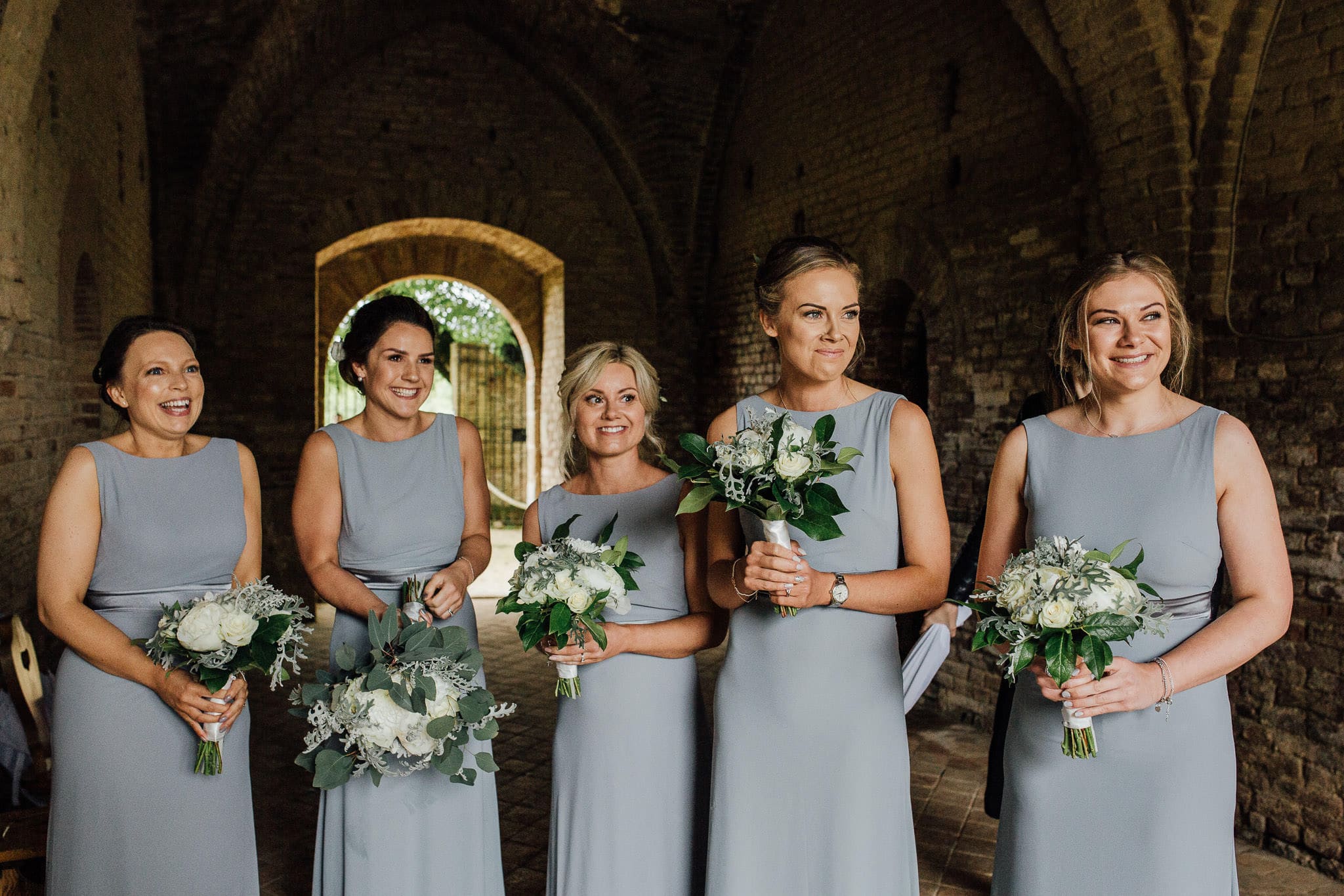 bridesmaids greet bride at San Galgano Abbey, Tuscany wedding