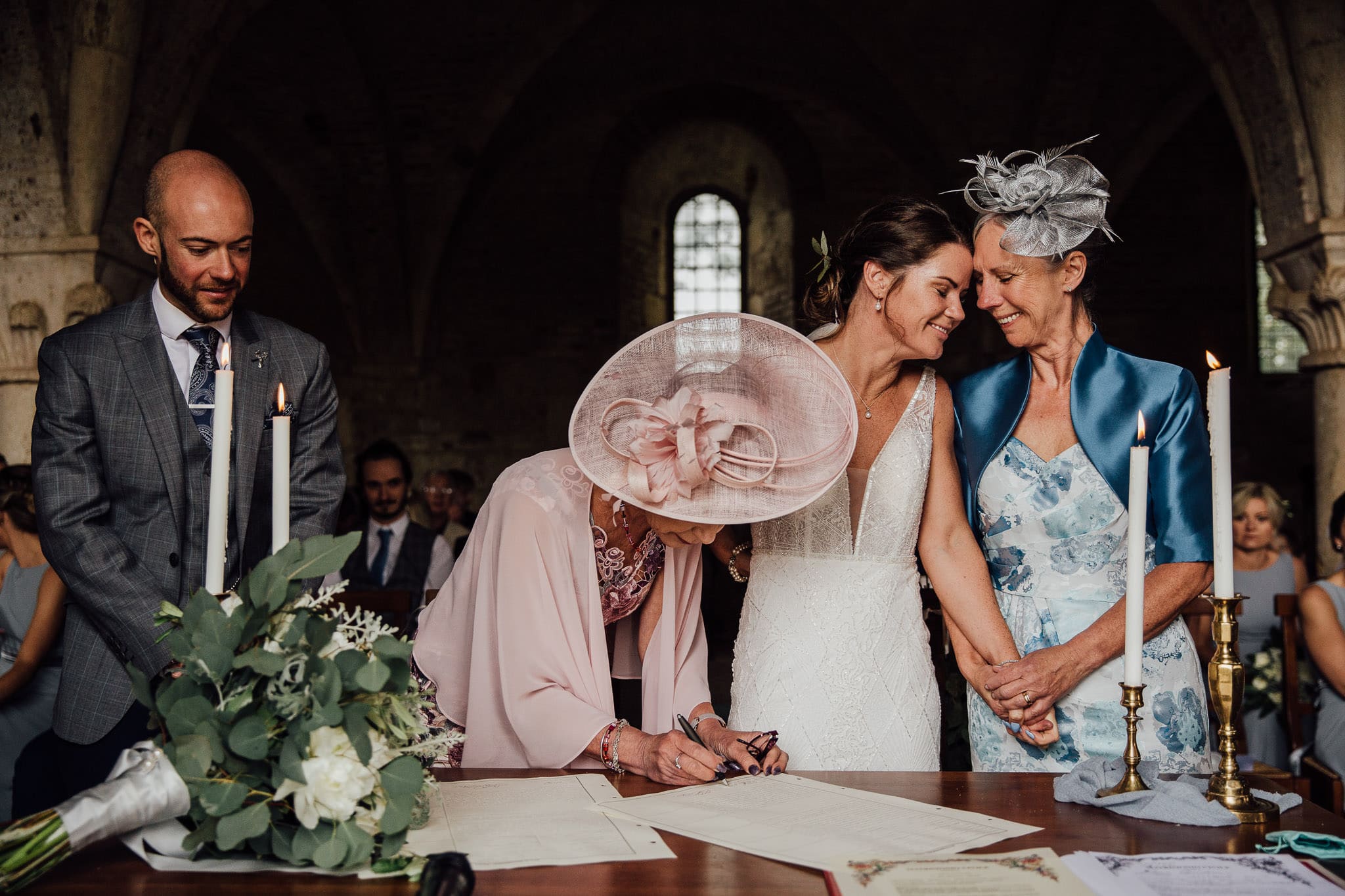 bride and her mum share a moment during signing of the register