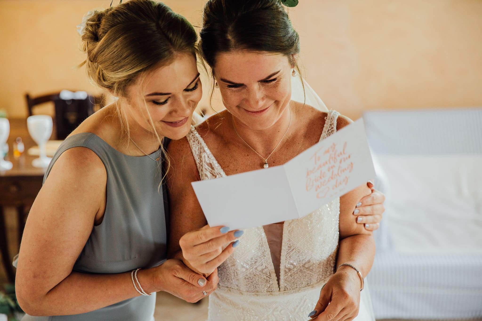 bride reading card on wedding morning