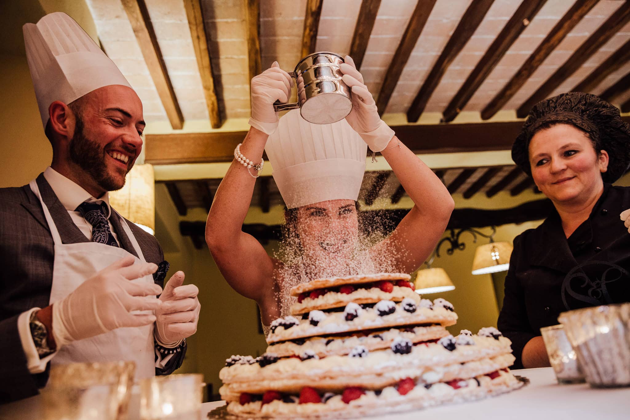 bride and groom make their Italian wedding cake