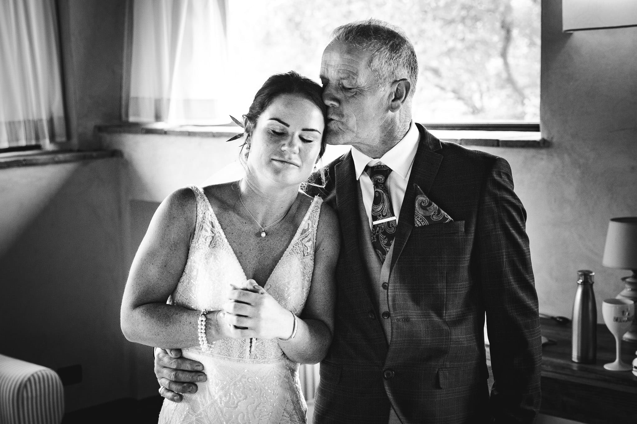 emotional moment father of the bride kisses his daughter