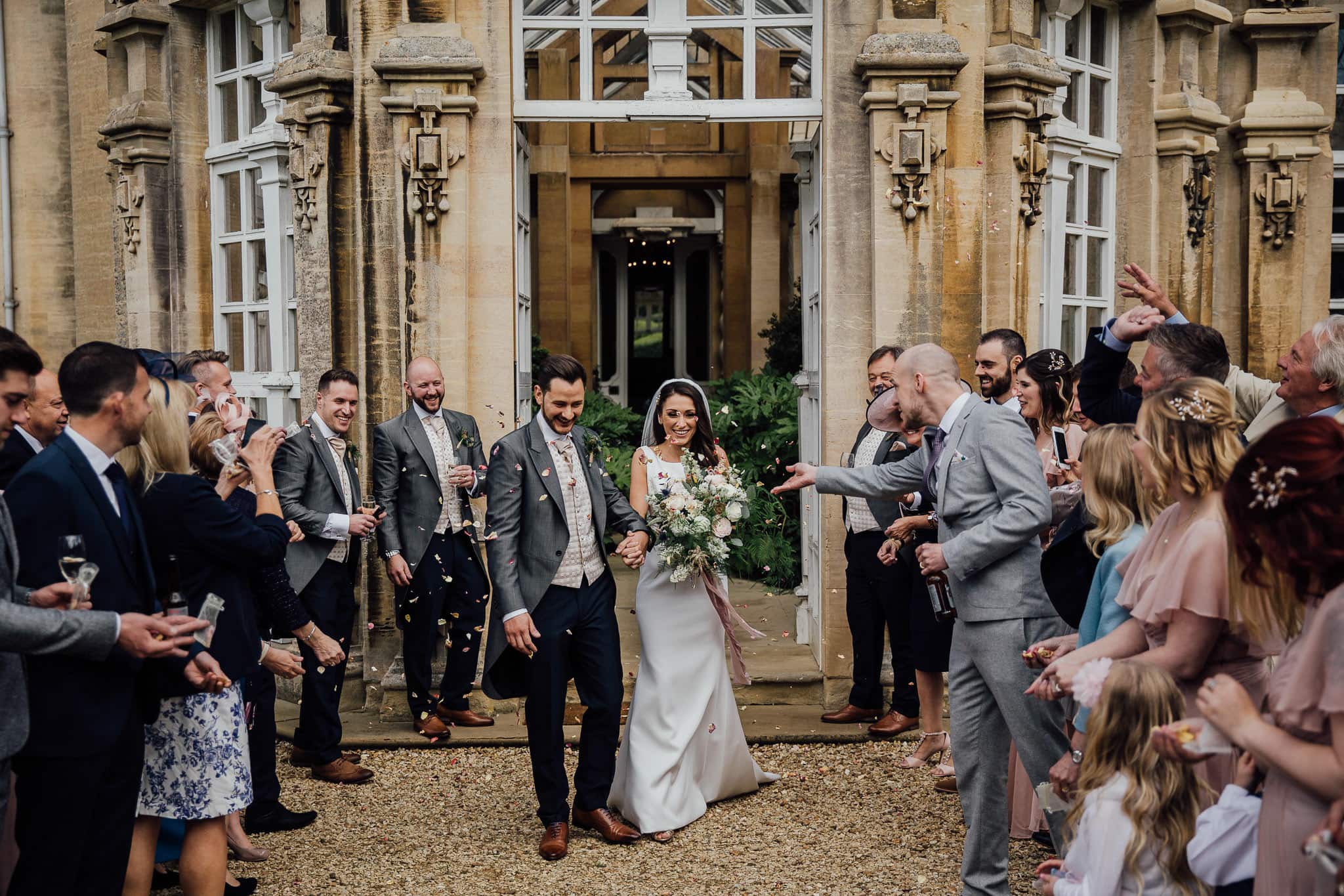 confetti outside the  orangery at Harlaxton Manor