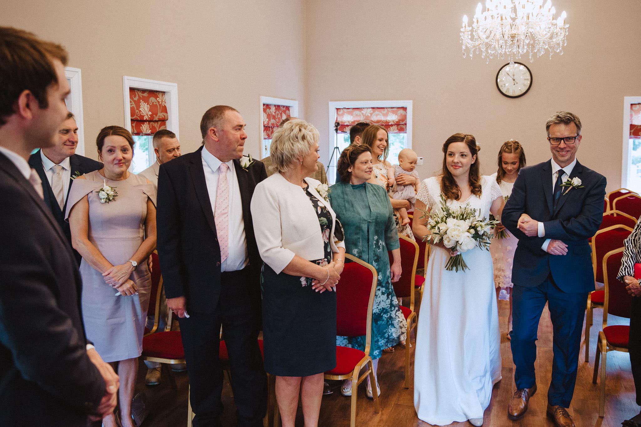bride and Father of the bride looking happy as she walks down the aisle at Bridgford Hall
