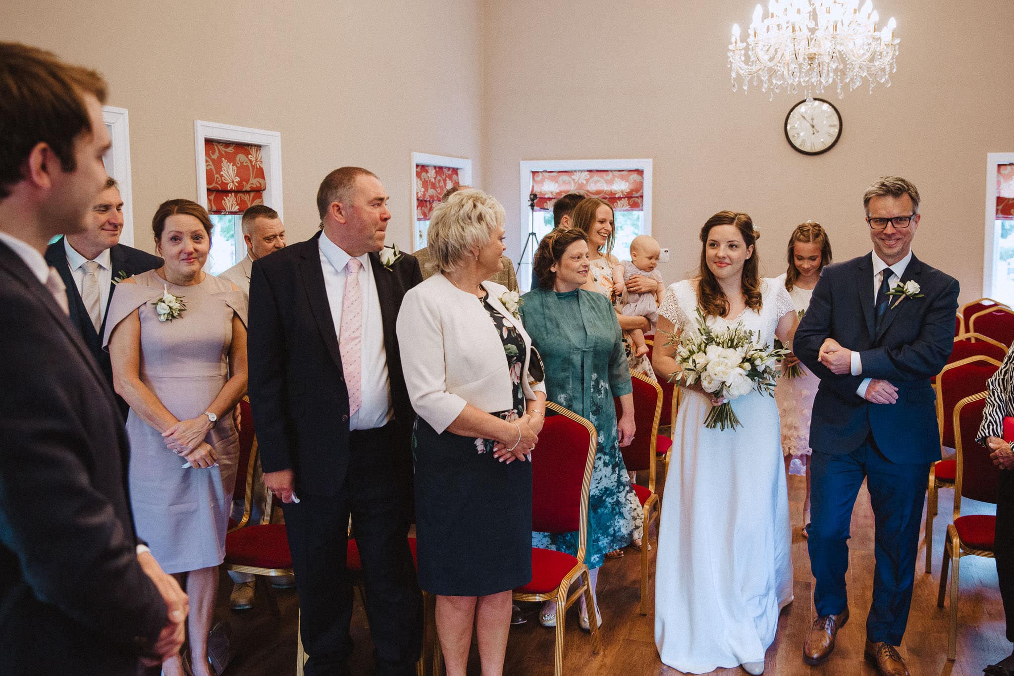 bride and Father of the bride looking happy as she walks down the aisle at Bridgford Hall