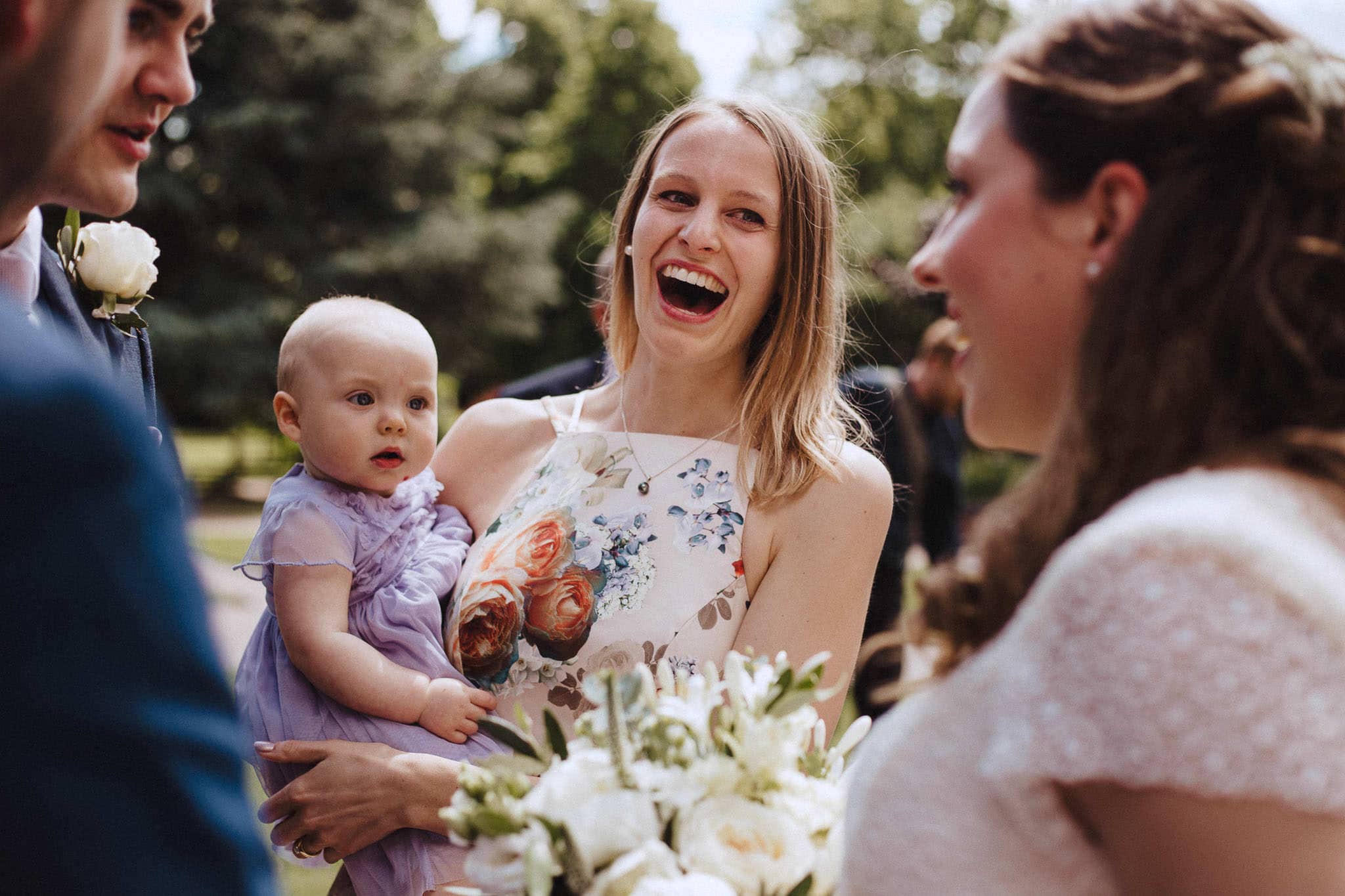 guests laughing with the bride in natural wedding photos by Nottingham photographer