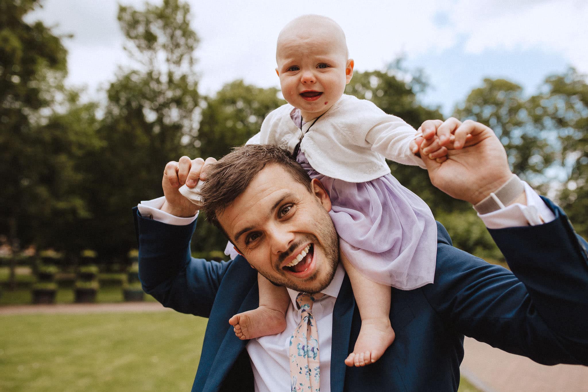 baby on Dad's shoulders enjoying the wedding at Bridgford Hall