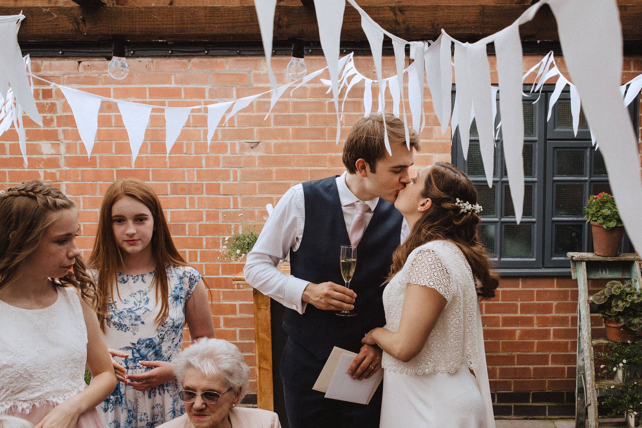 candid capture of bride and groom stealing a kiss
