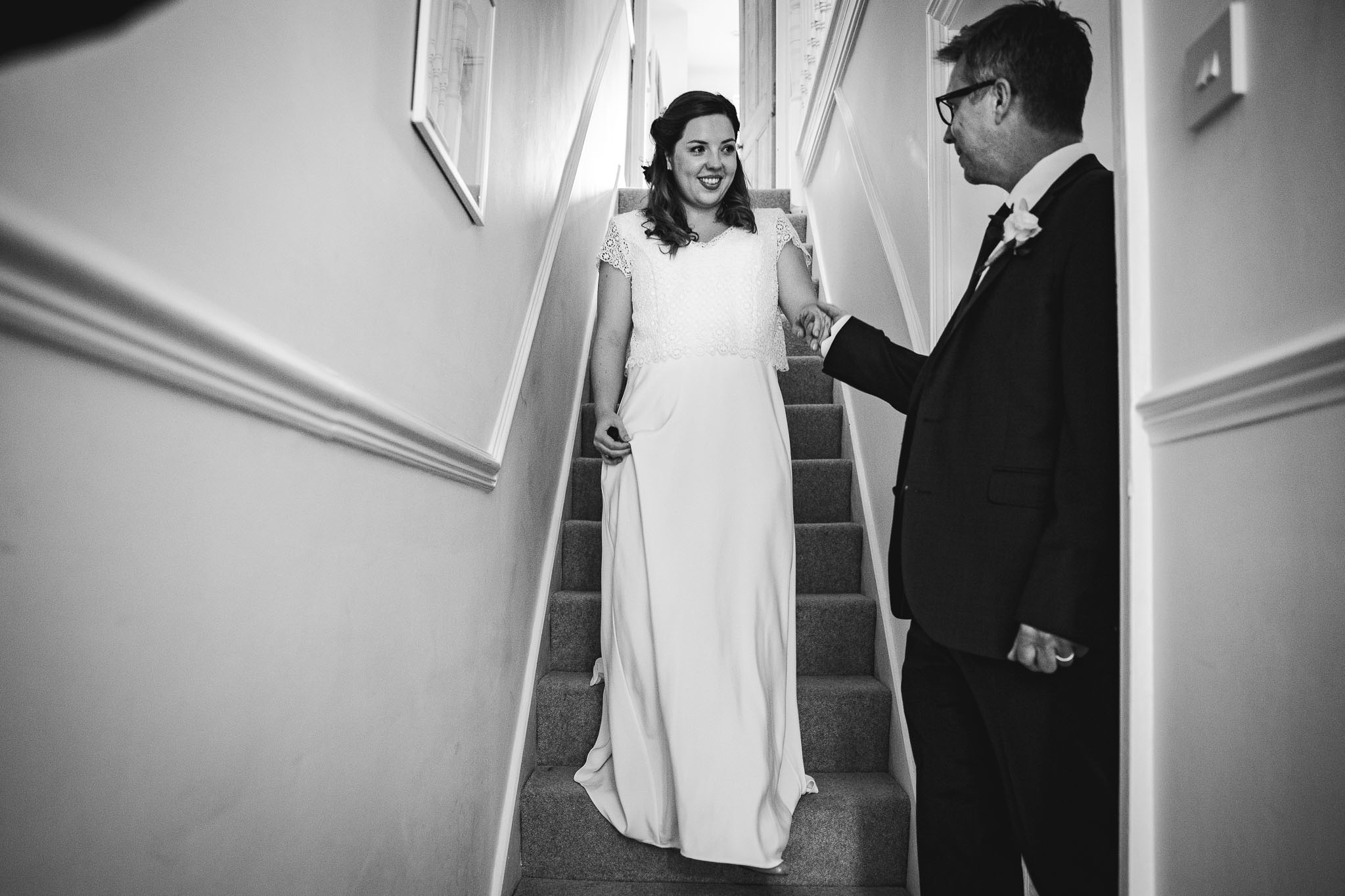 black and white photo of bride on the stairs at Bridgford Hall