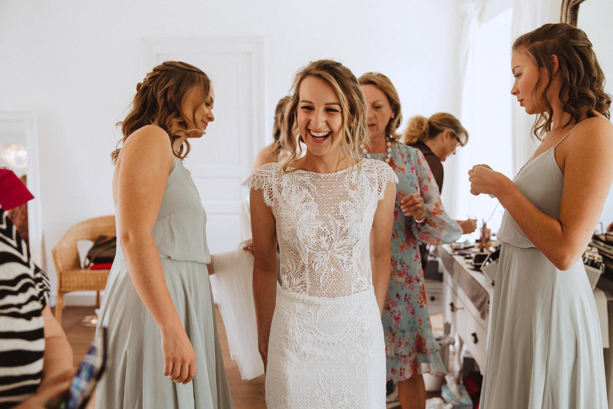 bride laughing with bridesmaids