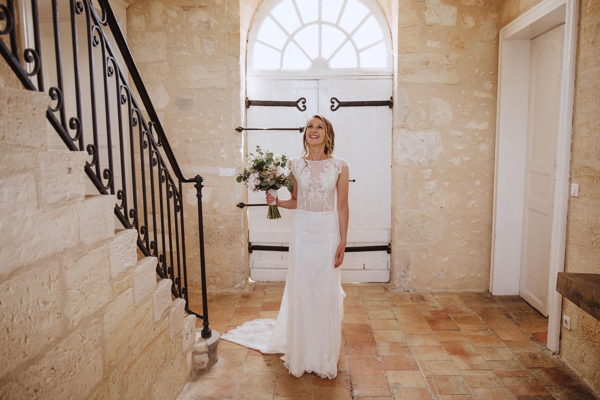 bride on staircase at Chateau Tourbeille wedding in France