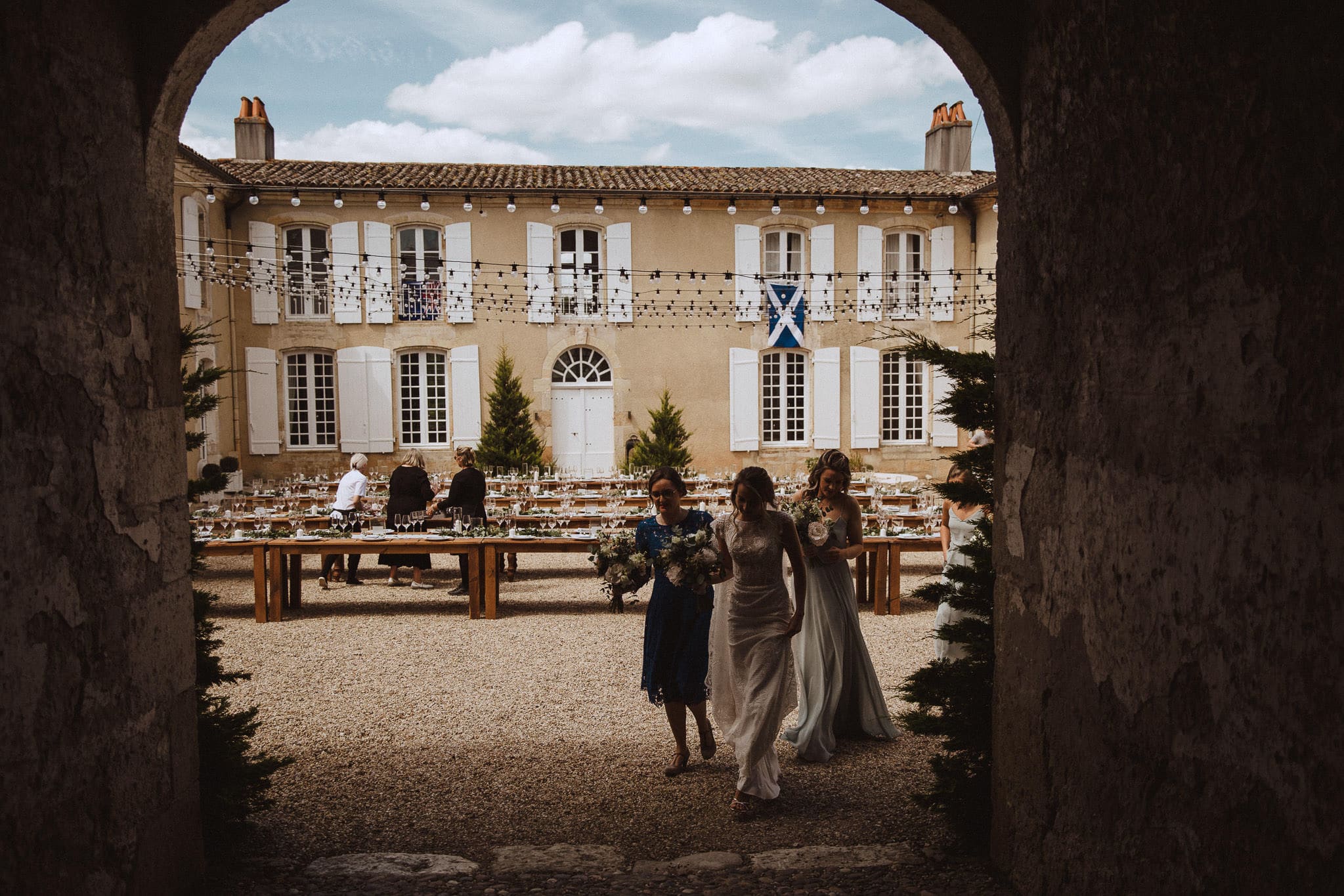 bride in courtyard at Chateau Tourbeille, Dordogne, France