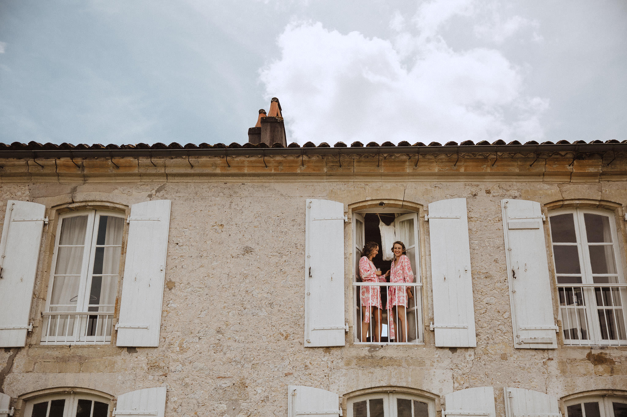 bride looking out the window at Chateau Tourbeille