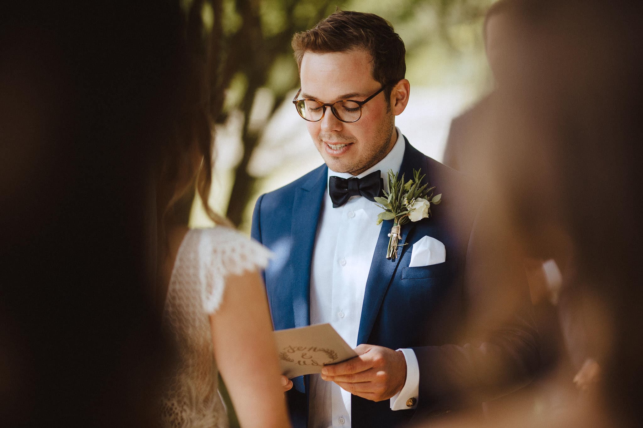 close up of groom reading personal wedding vows