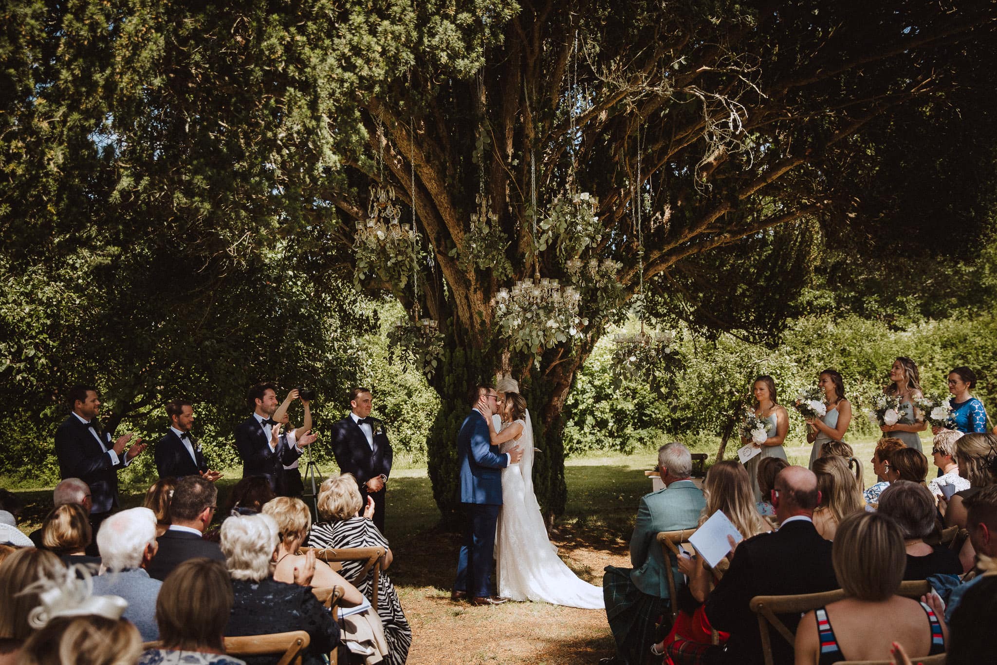 wide shot of first kiss under the trees at Chateau wedding in France