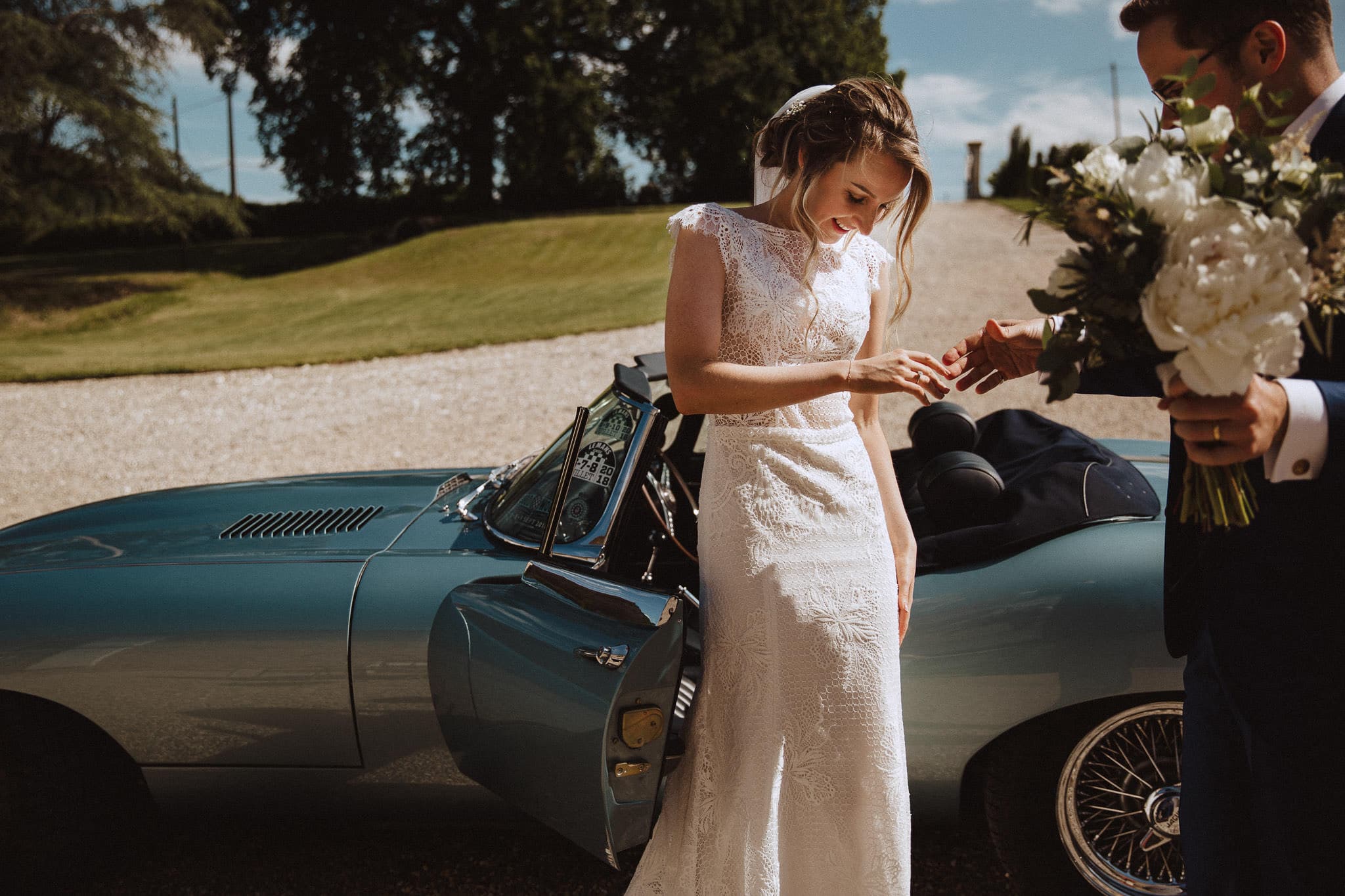 bride with beautiful e type Jaguar wedding car