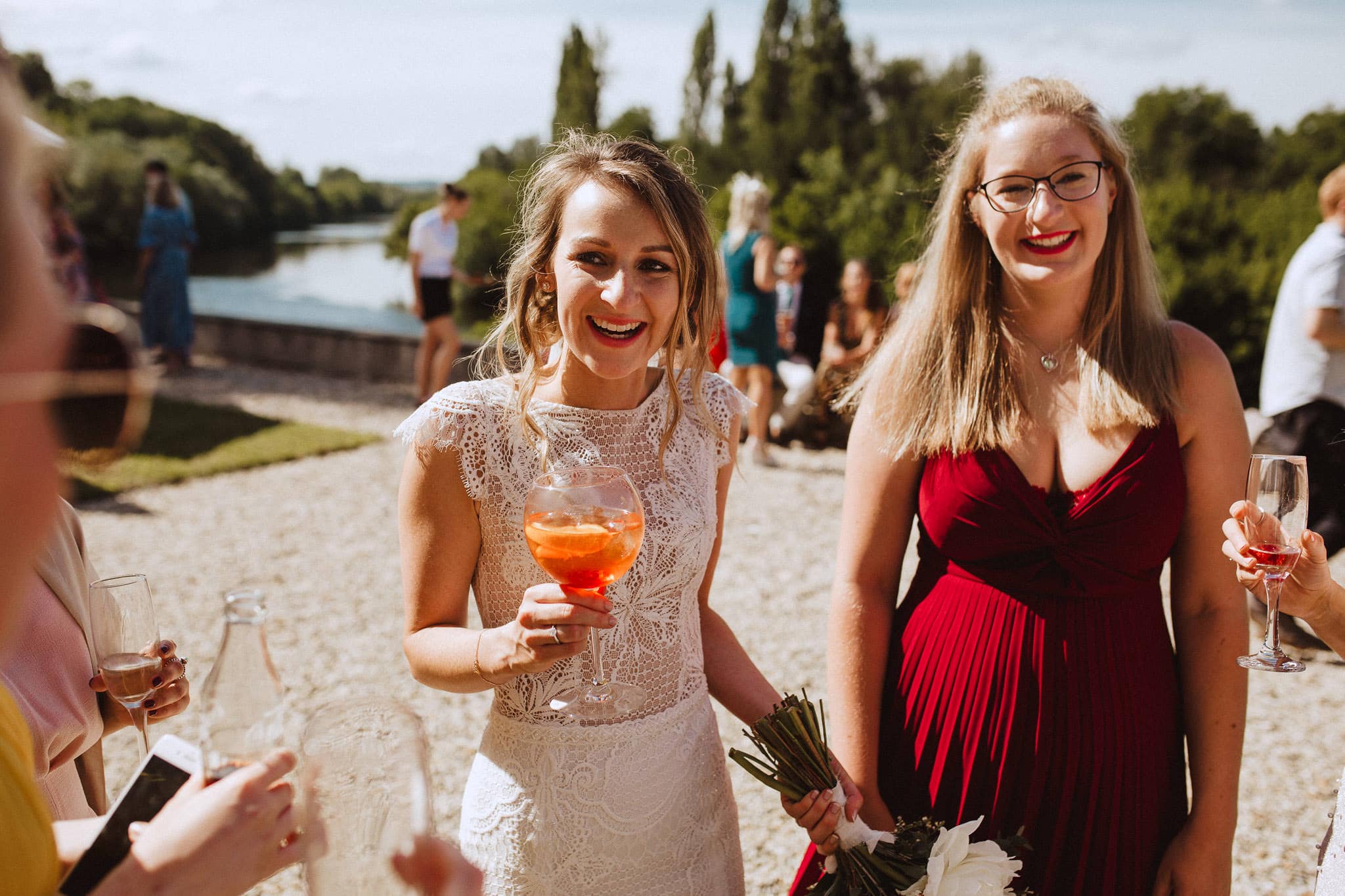bride laughing with friends during drinks reception at Chateau Tourbeille