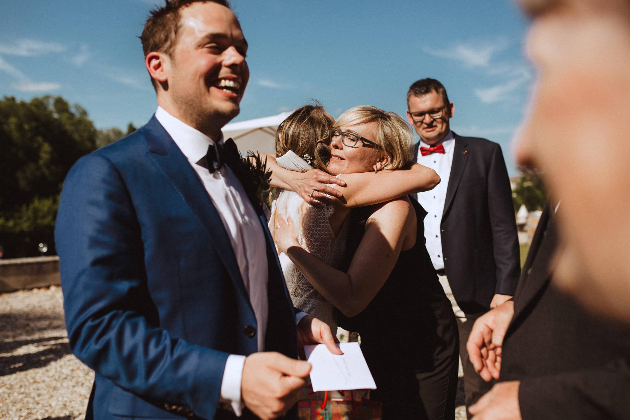 hugging the bride at wedding