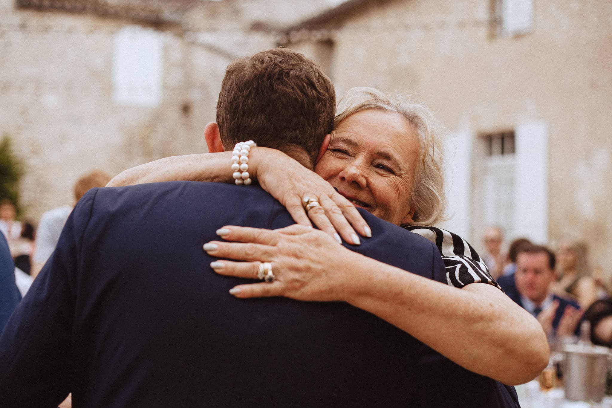 mother of the groom hugging the best man