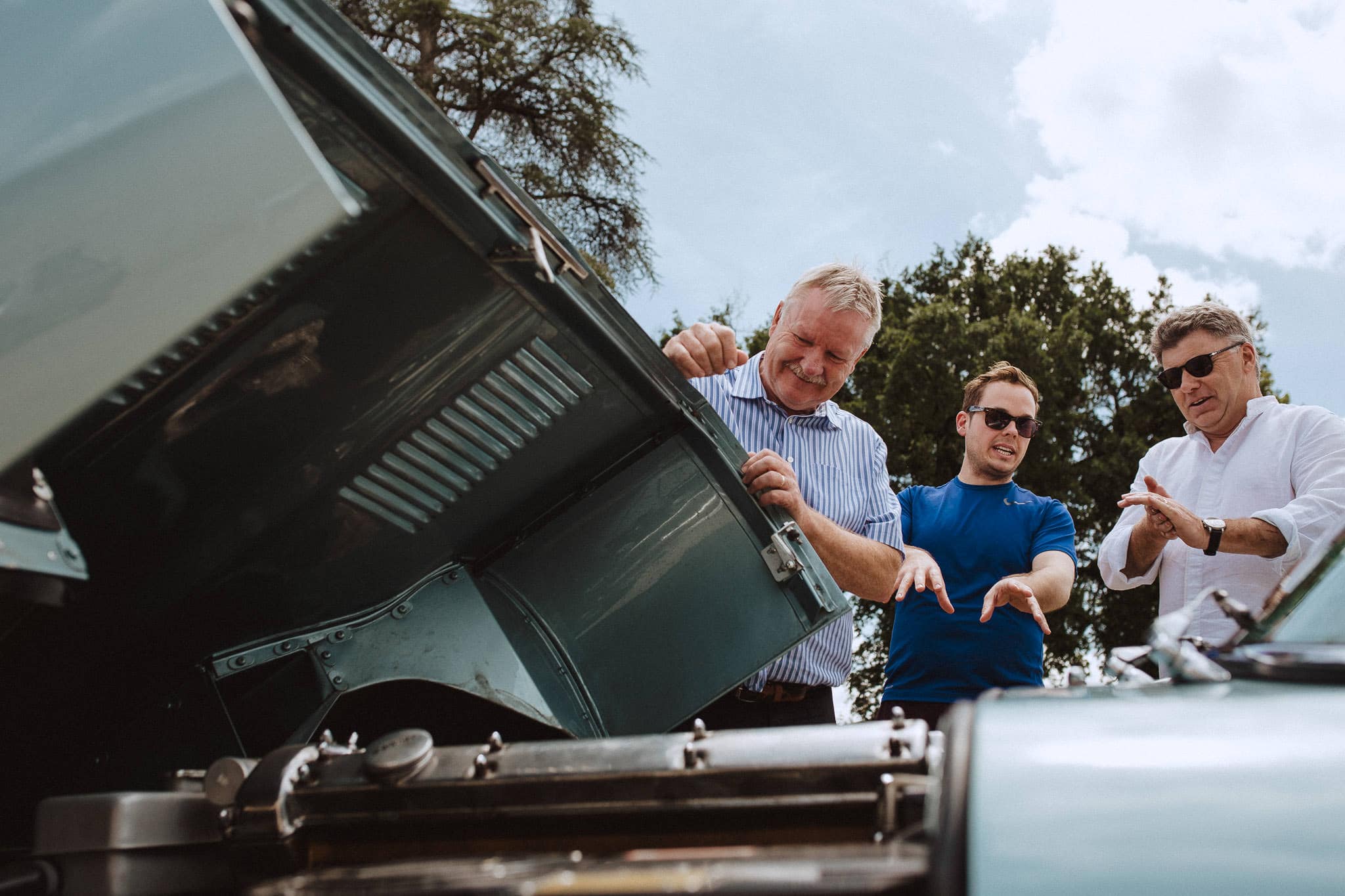 groom fixing E type Jaguar on wedding morning