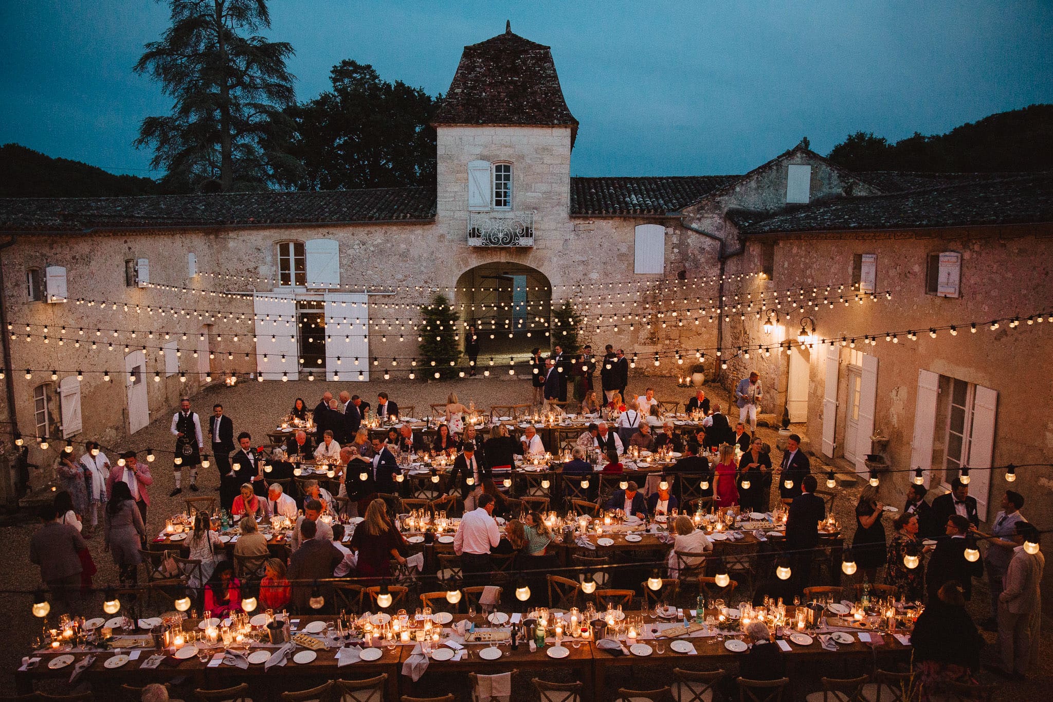 festoon lit courtyard at Chateau Tourbeille France