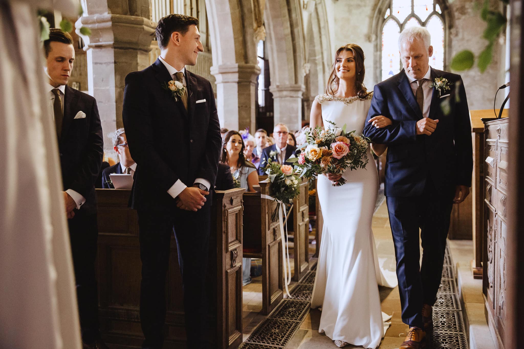 beautiful bride walking down the aisle in Pronovias wedding dress