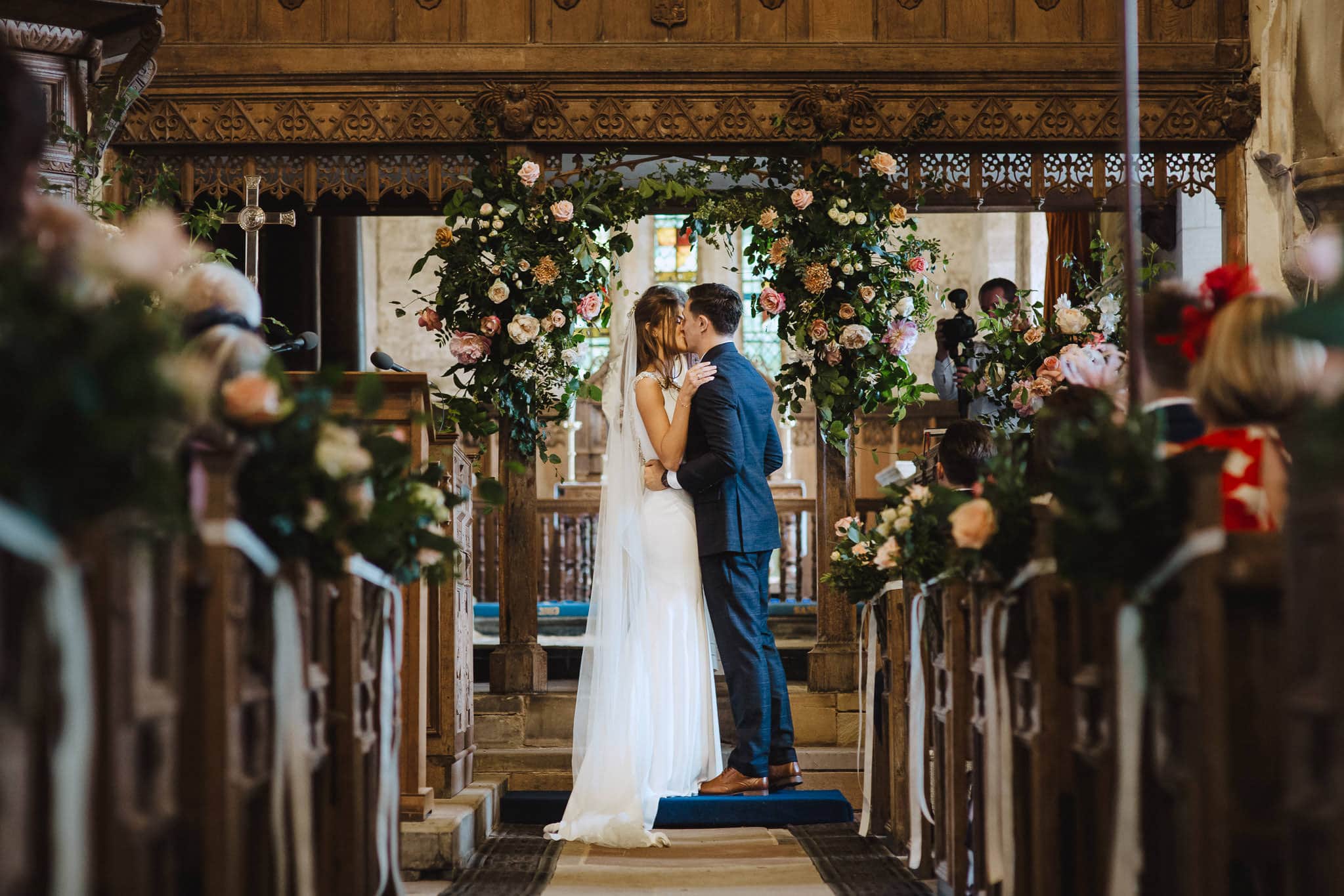 first kiss under the floral arch