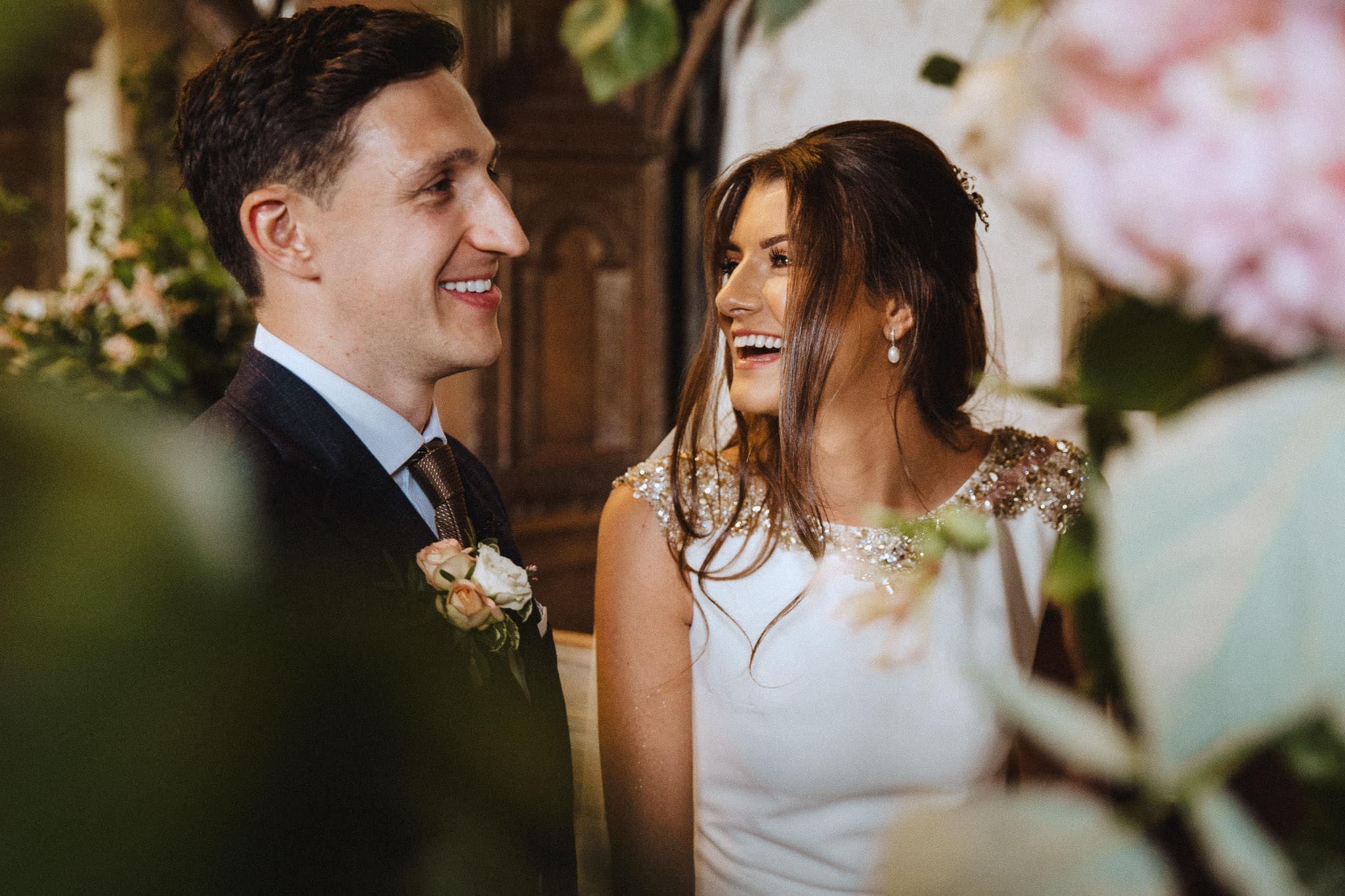 close up of bride and groom laughing 