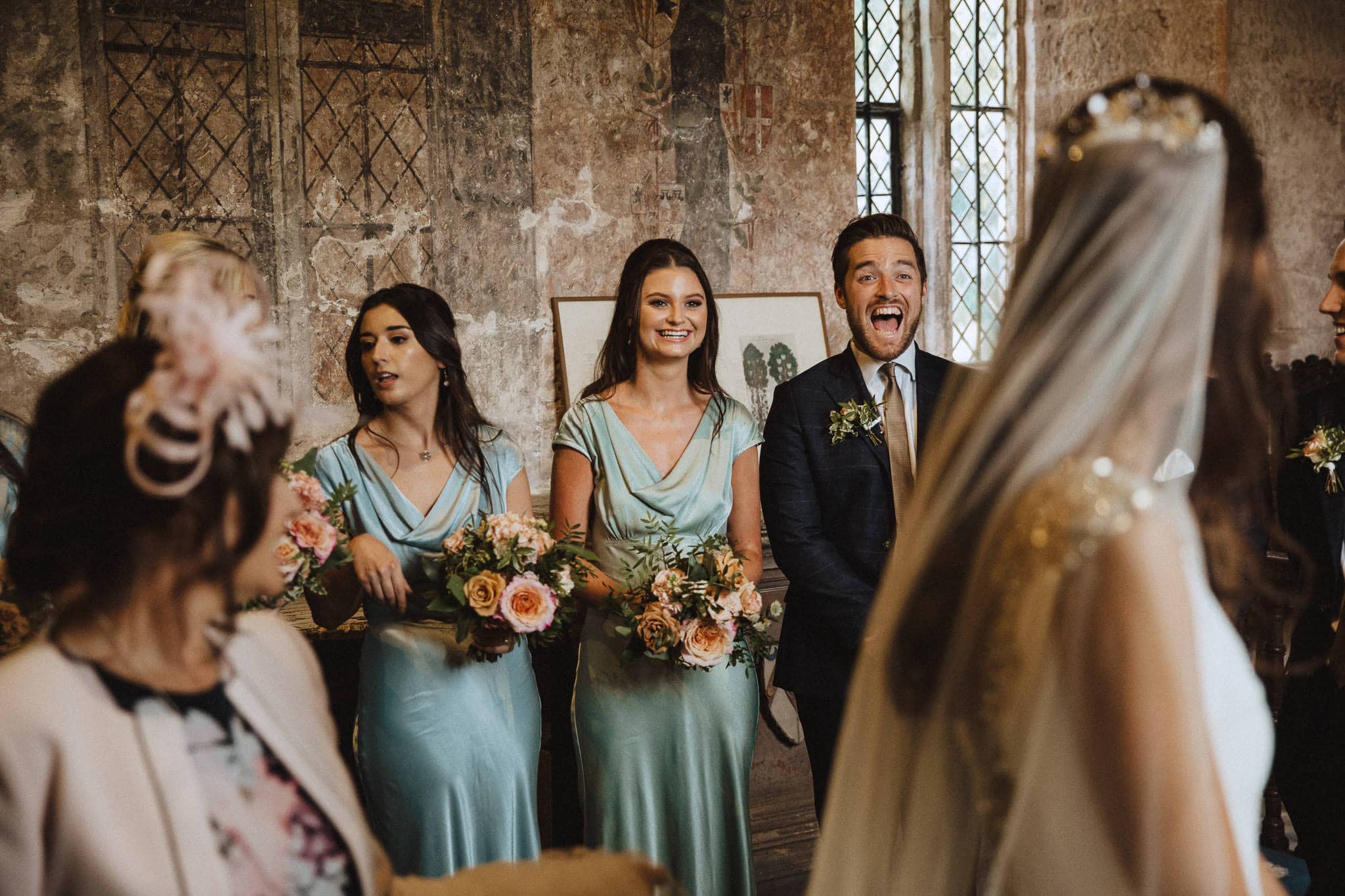 bridal party excited as bride and groom sign the register