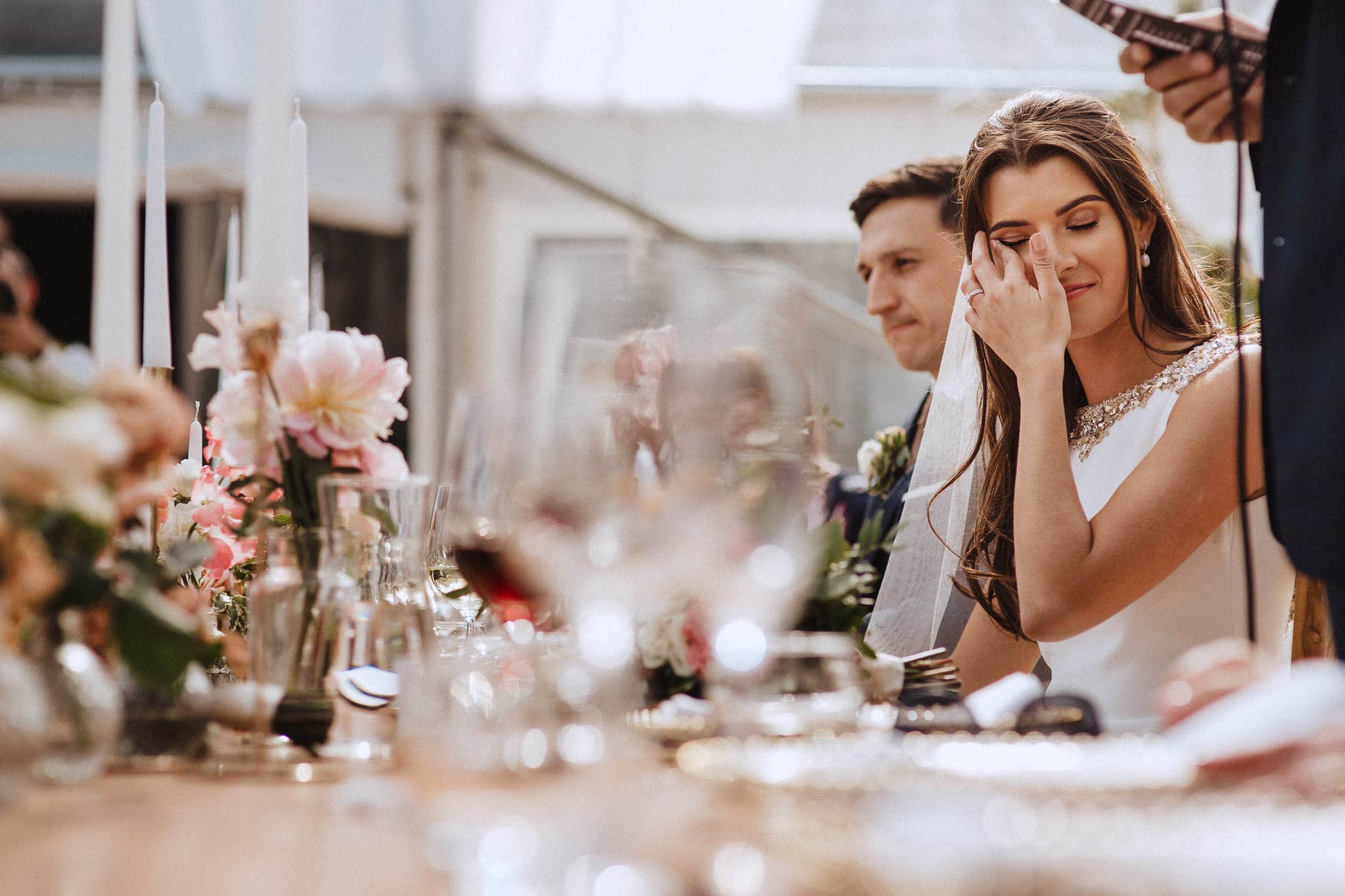 bride wiping away a tear during her Dad's speech