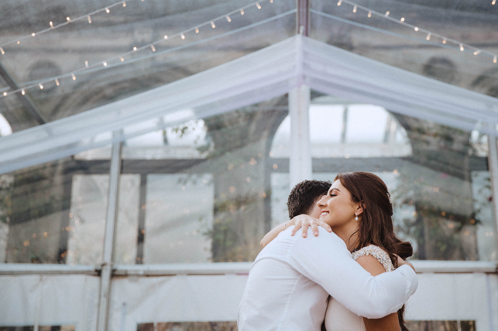 bride and groom hugging