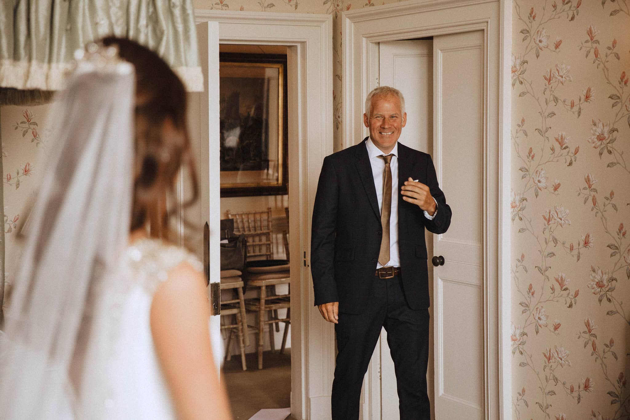 happy Father of the Bride seeing her wedding dress for the first time