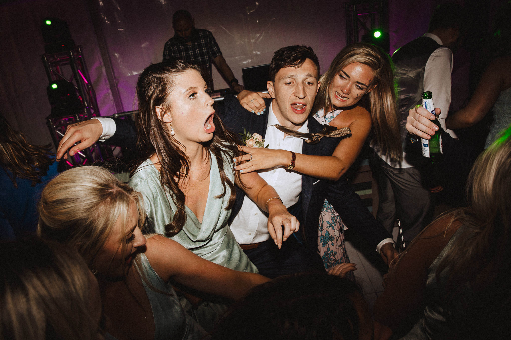 groom in dance floor shape throwing sandwich