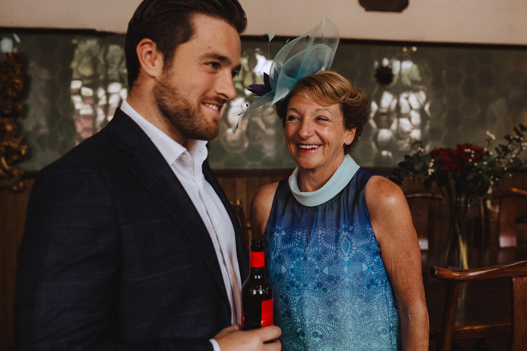 mother of the groom laughing with his ushers