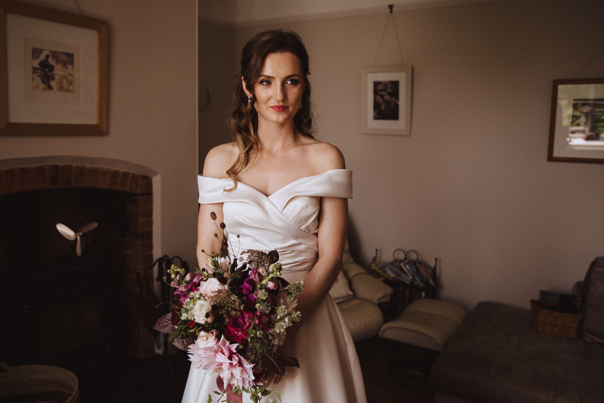Portrait of bride in bardot neckline Art Couture dress ready for her Marquee Wedding at Home