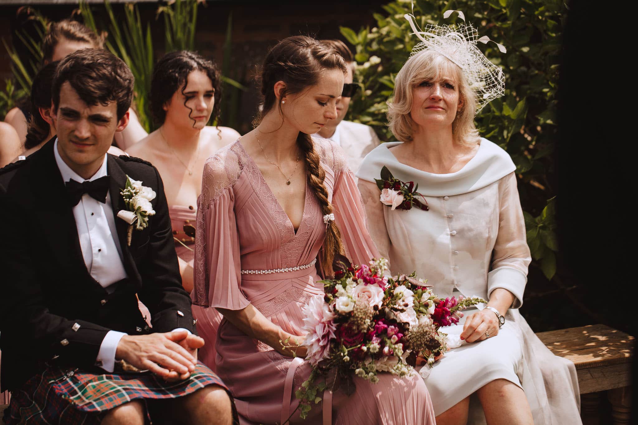 mother of the bride and maid of honour crying during wedding vows