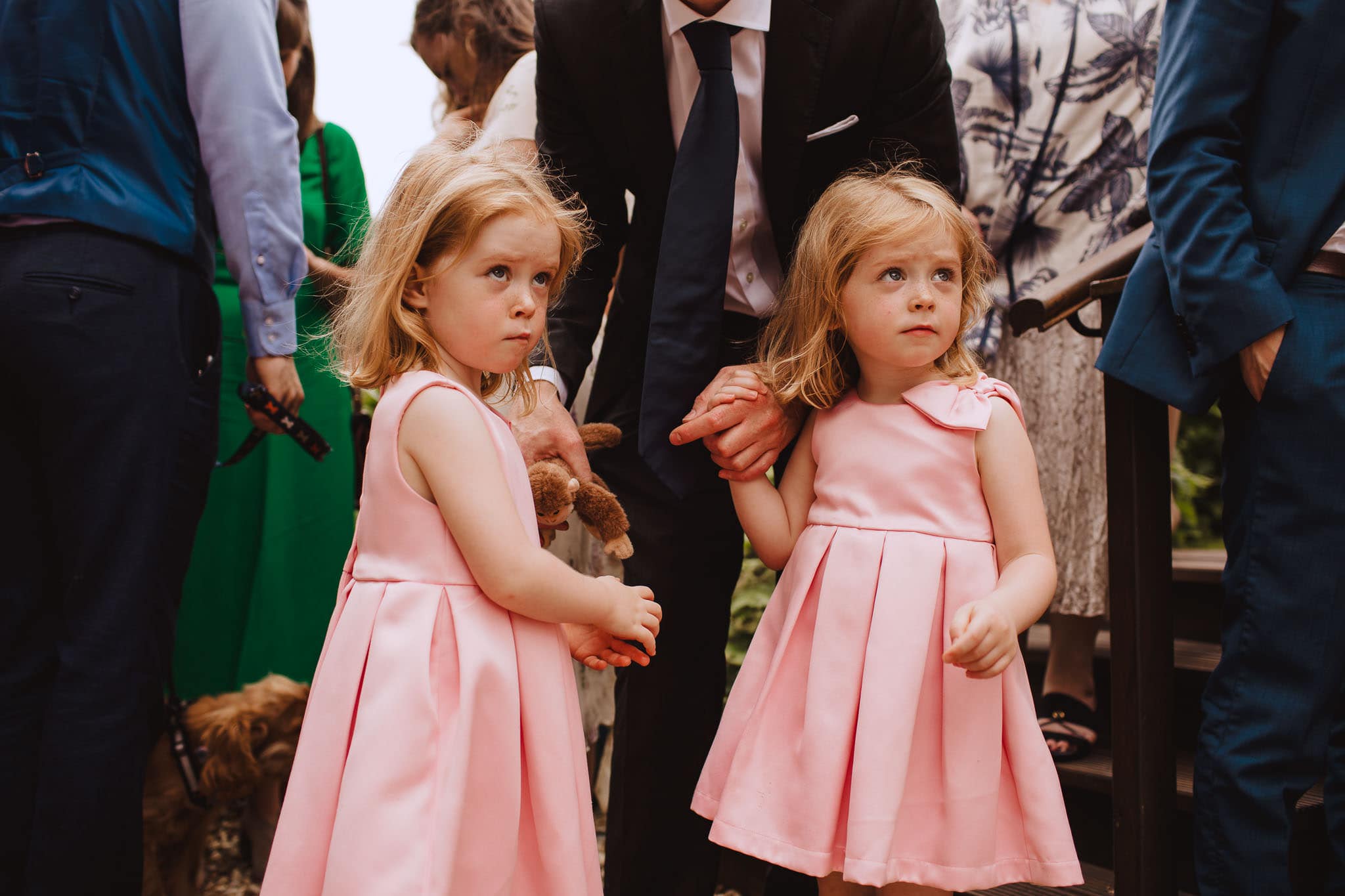 twin flower girls in matching pink dresses
