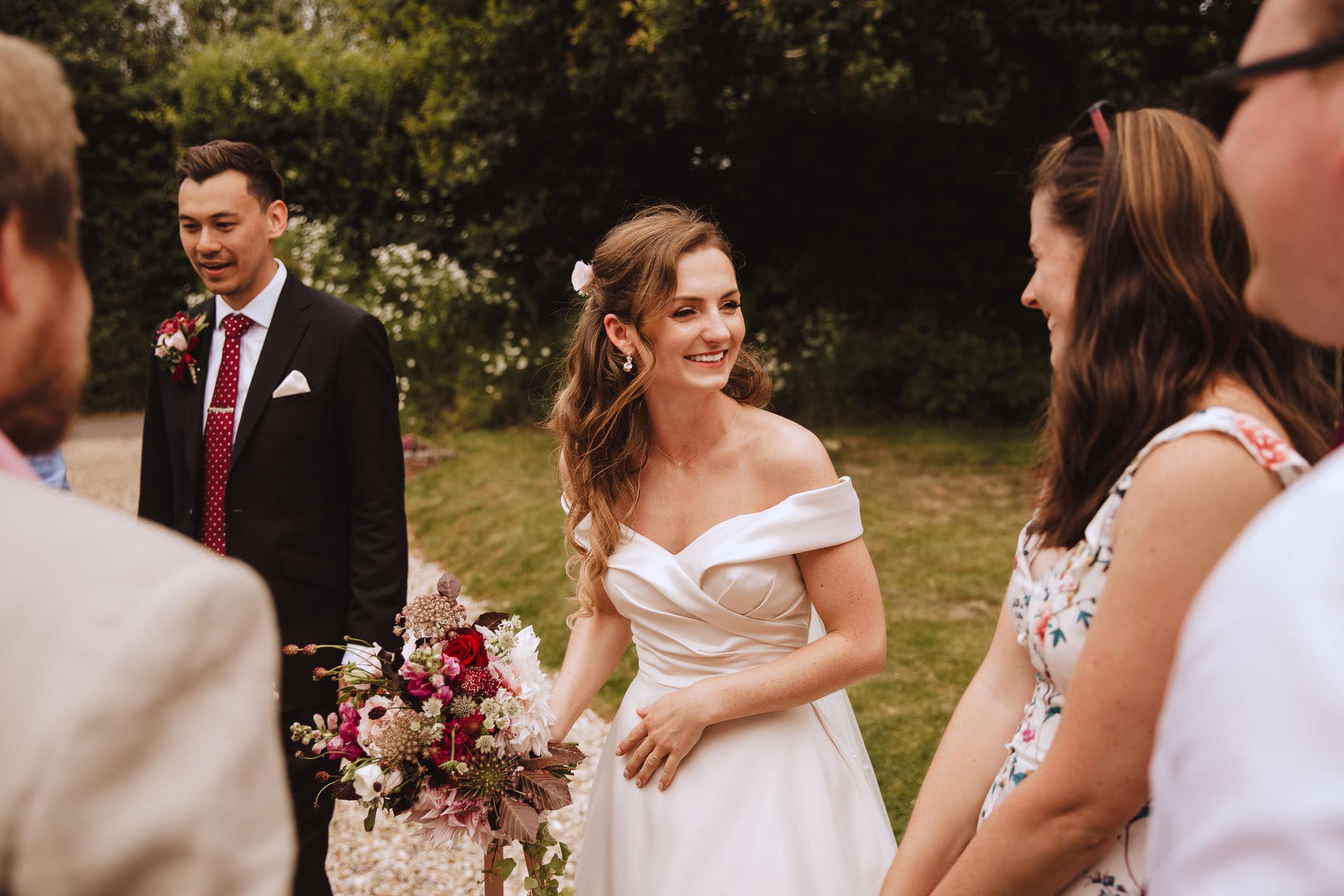 bride laughing with guests at her Marquee Wedding at Home