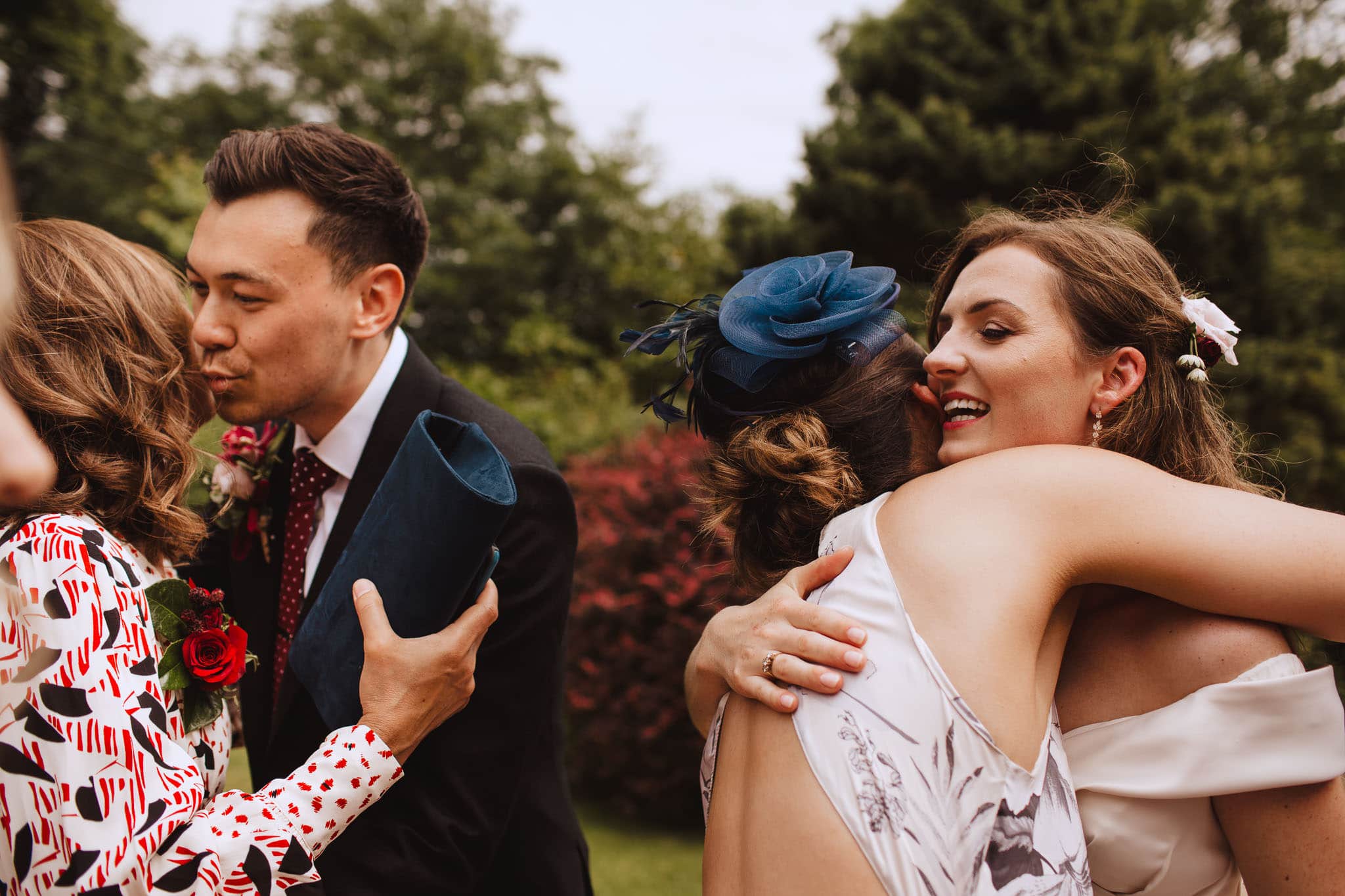 bride and groom hugging family