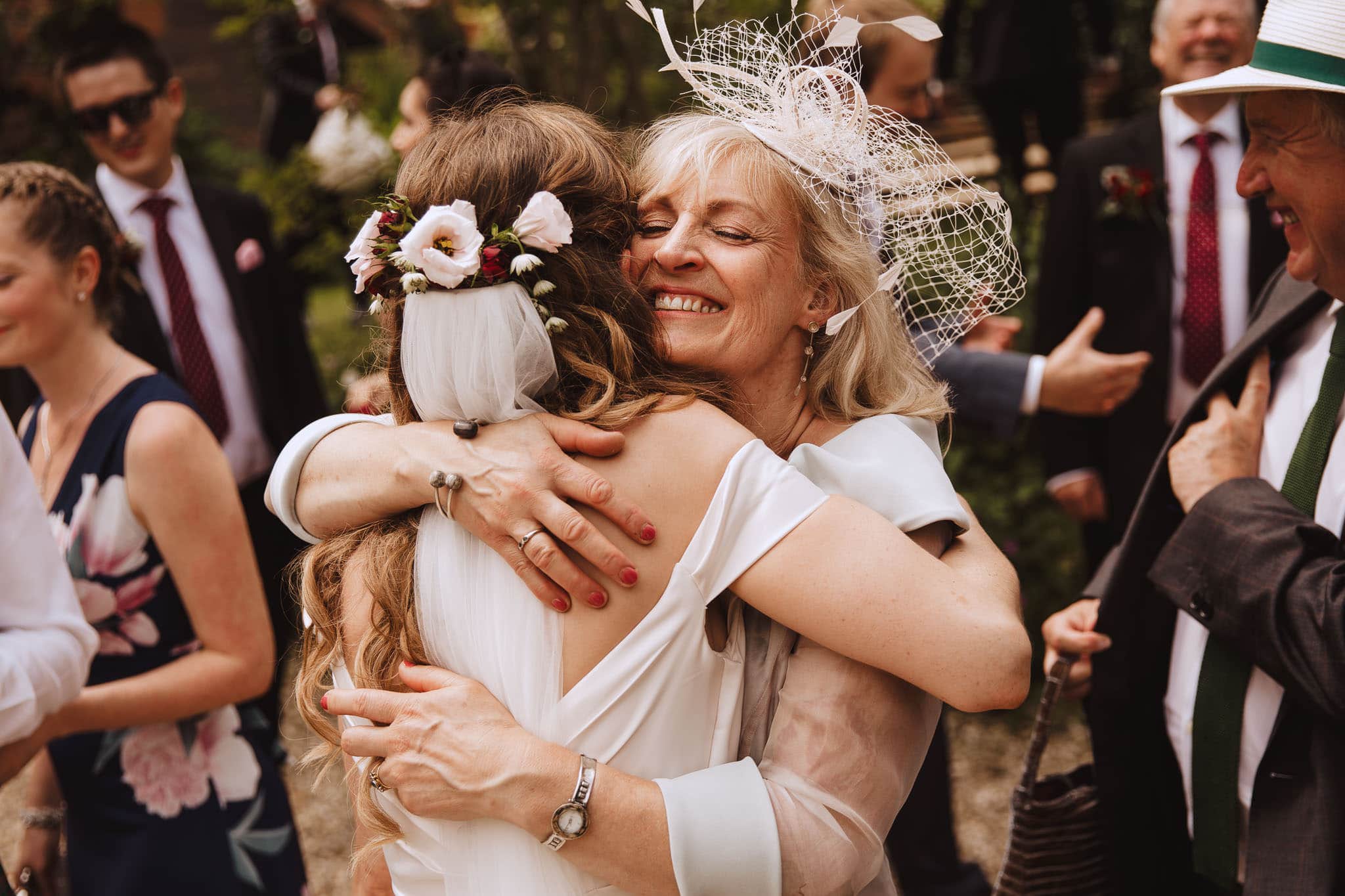 mother of the bride hugging her daughter and congratulating her