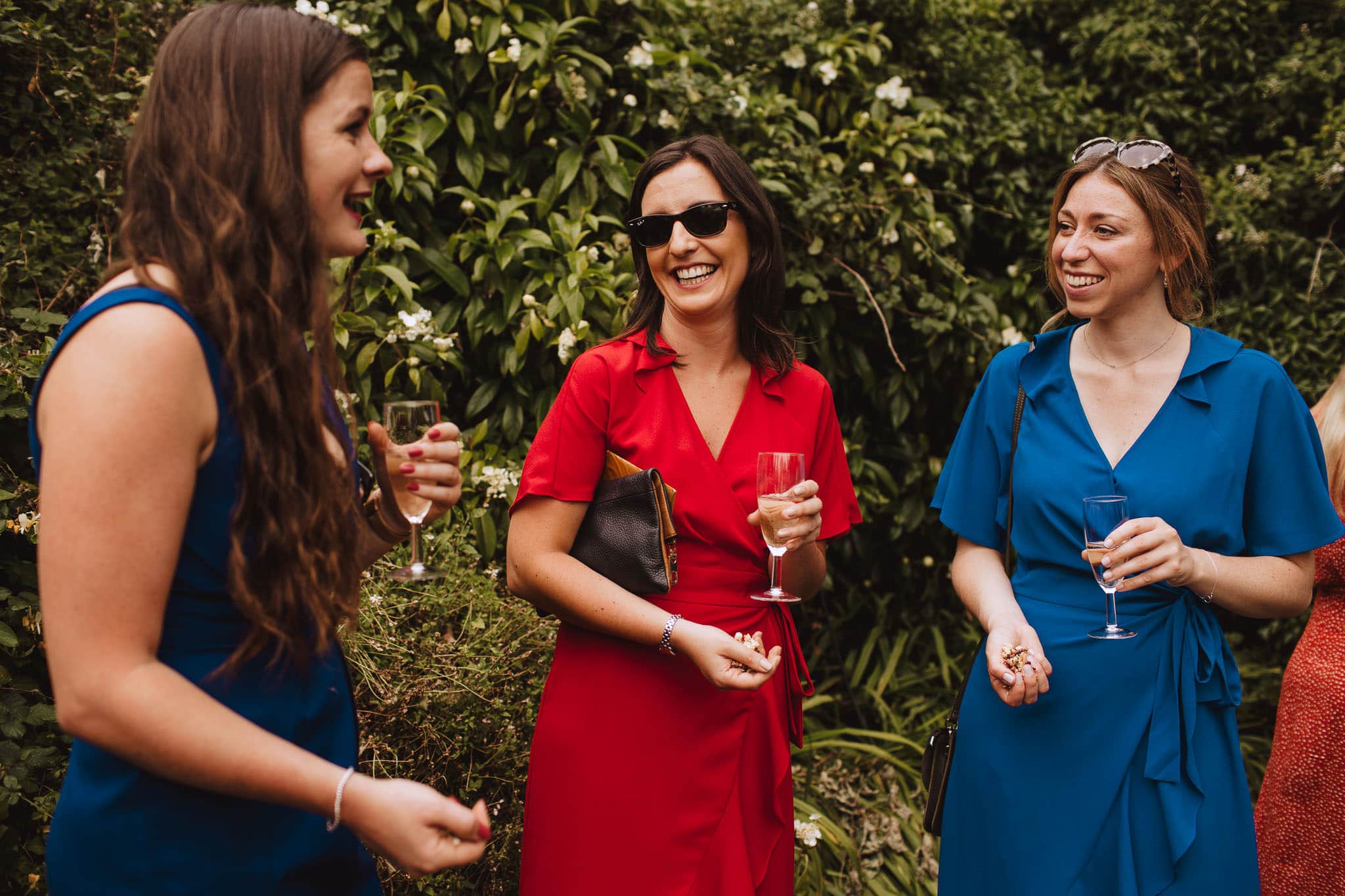 wedding guests in bold colour dresses