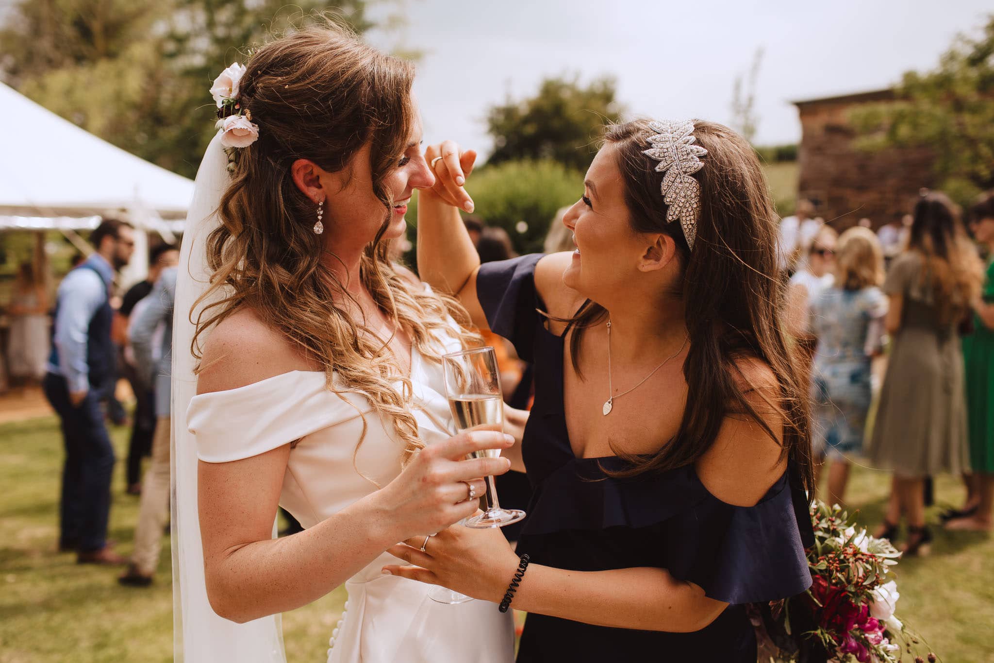 bride's friend wiping her tears