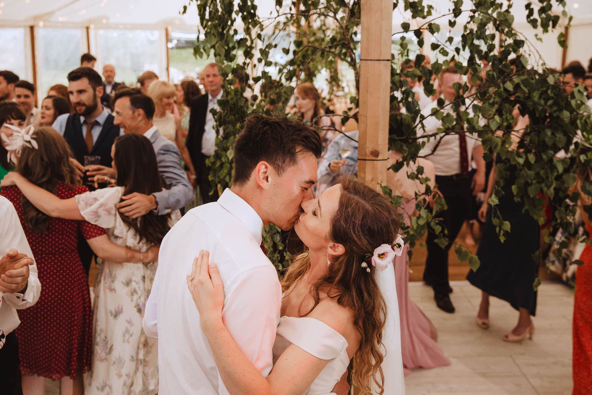 bride and groom steal a kiss on the dance floor