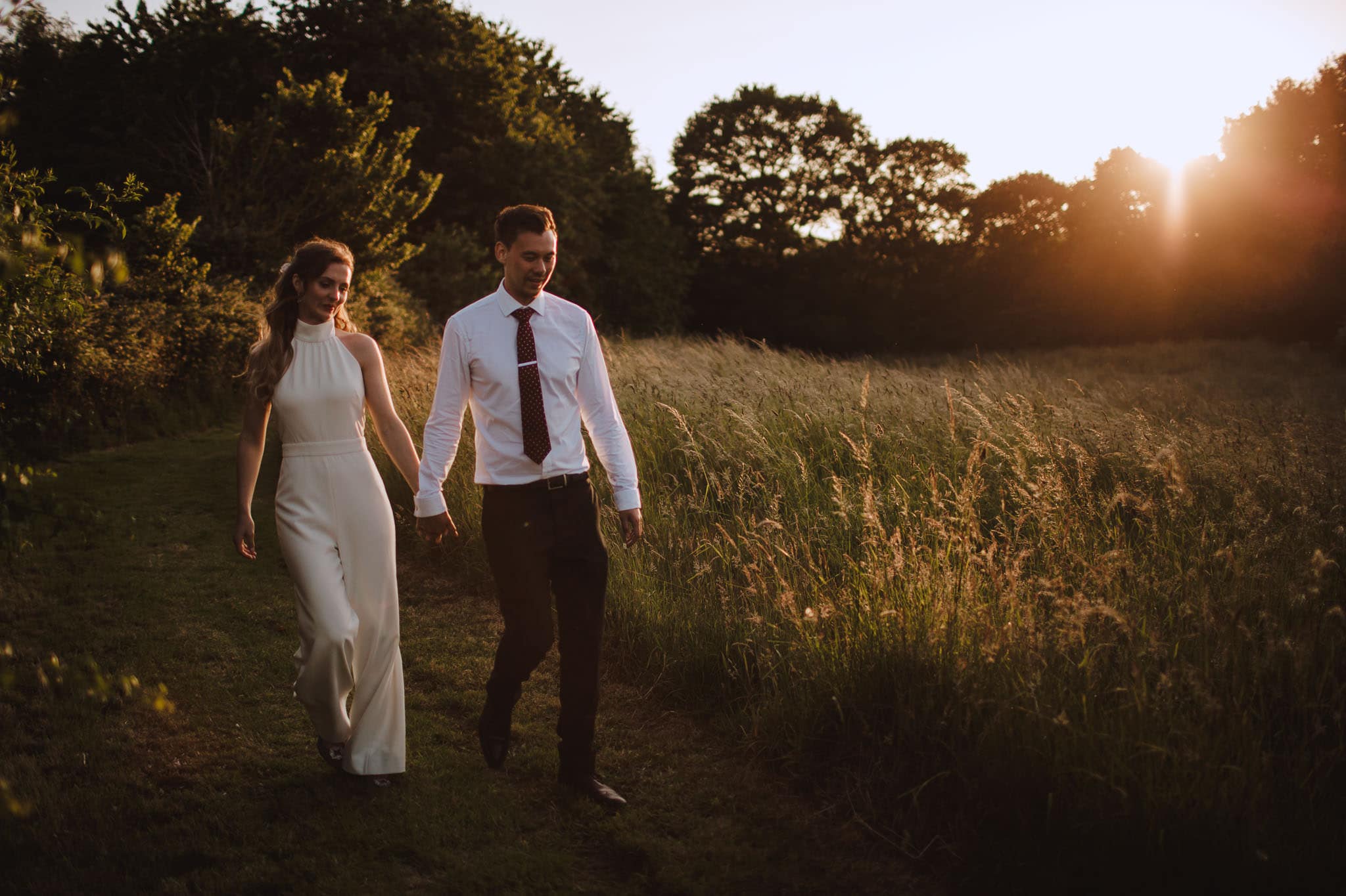 bride and groom walking back to their marquee to party at their Marquee Wedding at Home