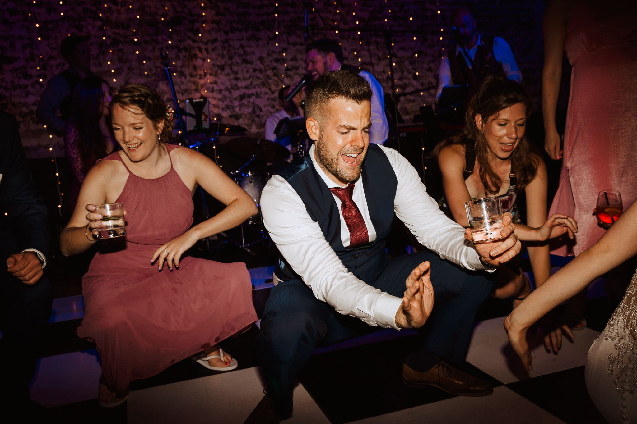 bridal party going crazy on the dance floor