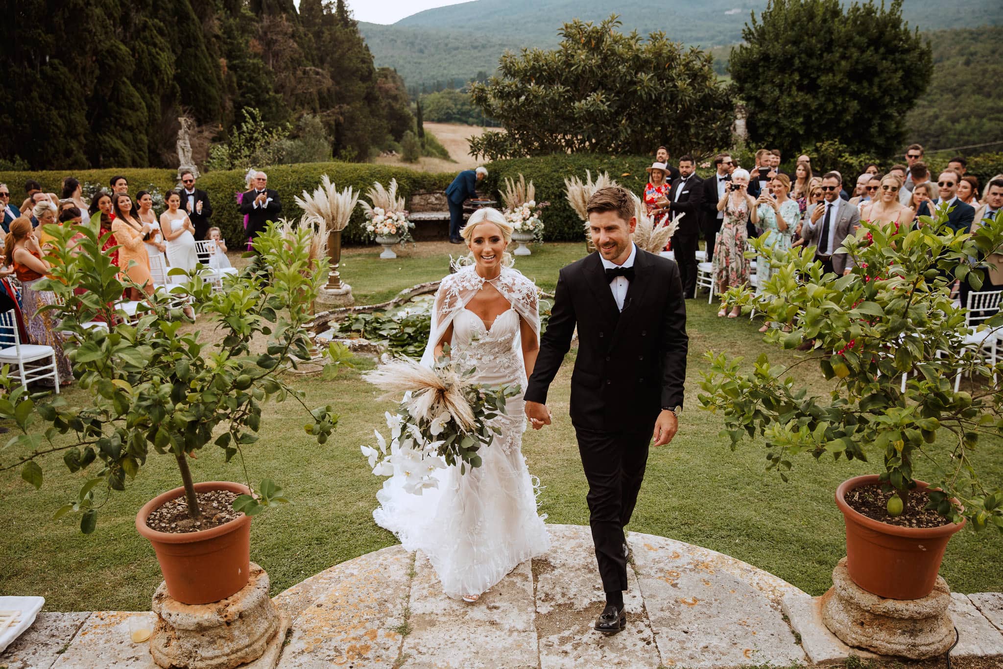bride and groom exit their ceremony at Borgo Stomennano Wedding