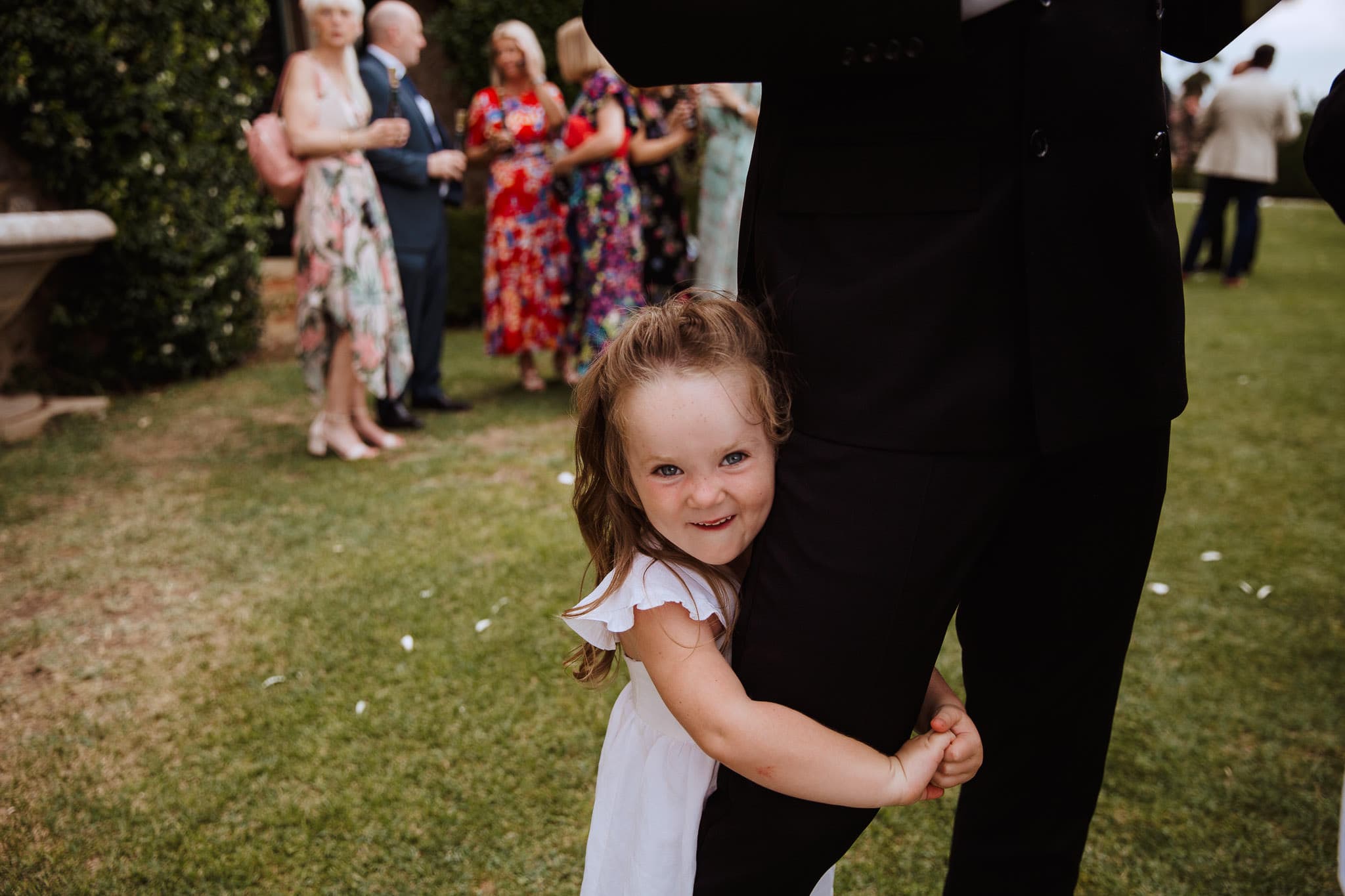 cute flower girl in white dress at Borgo Stomennano Wedding