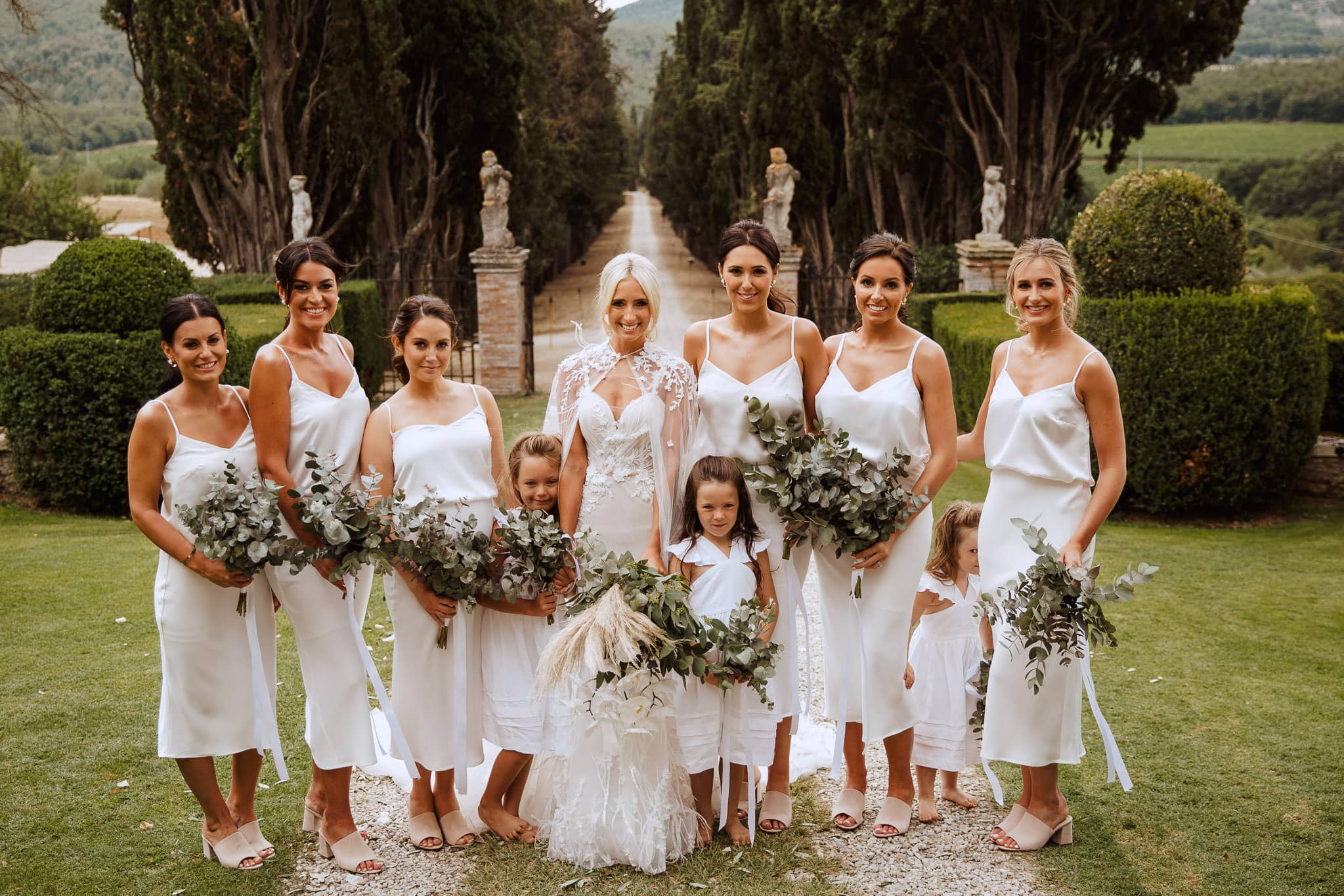 bride and bridesmaids all in white at Borgo Stomennano Wedding