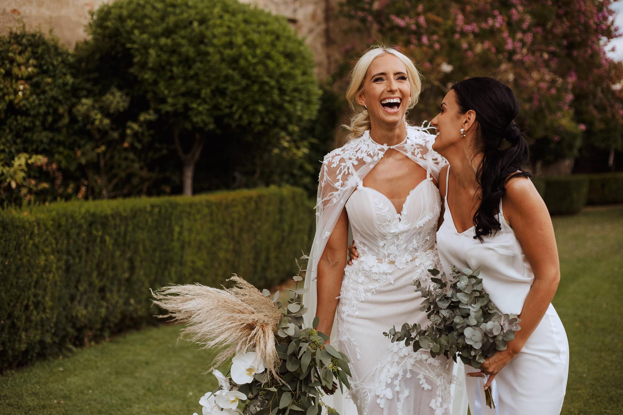 bride laughing with her bridesmaid 