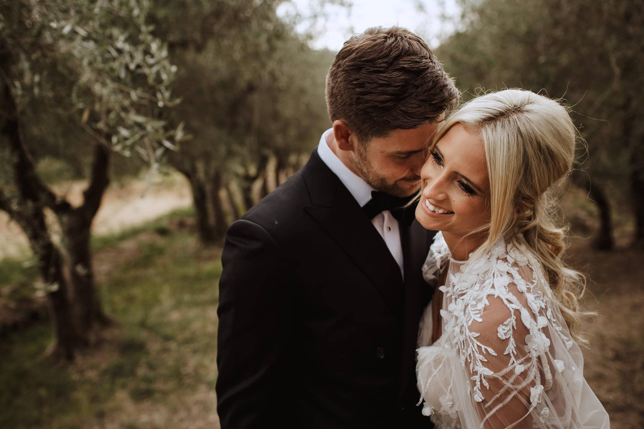 close up of bride and groom in the olive grove at Borgo Stomennano Wedding